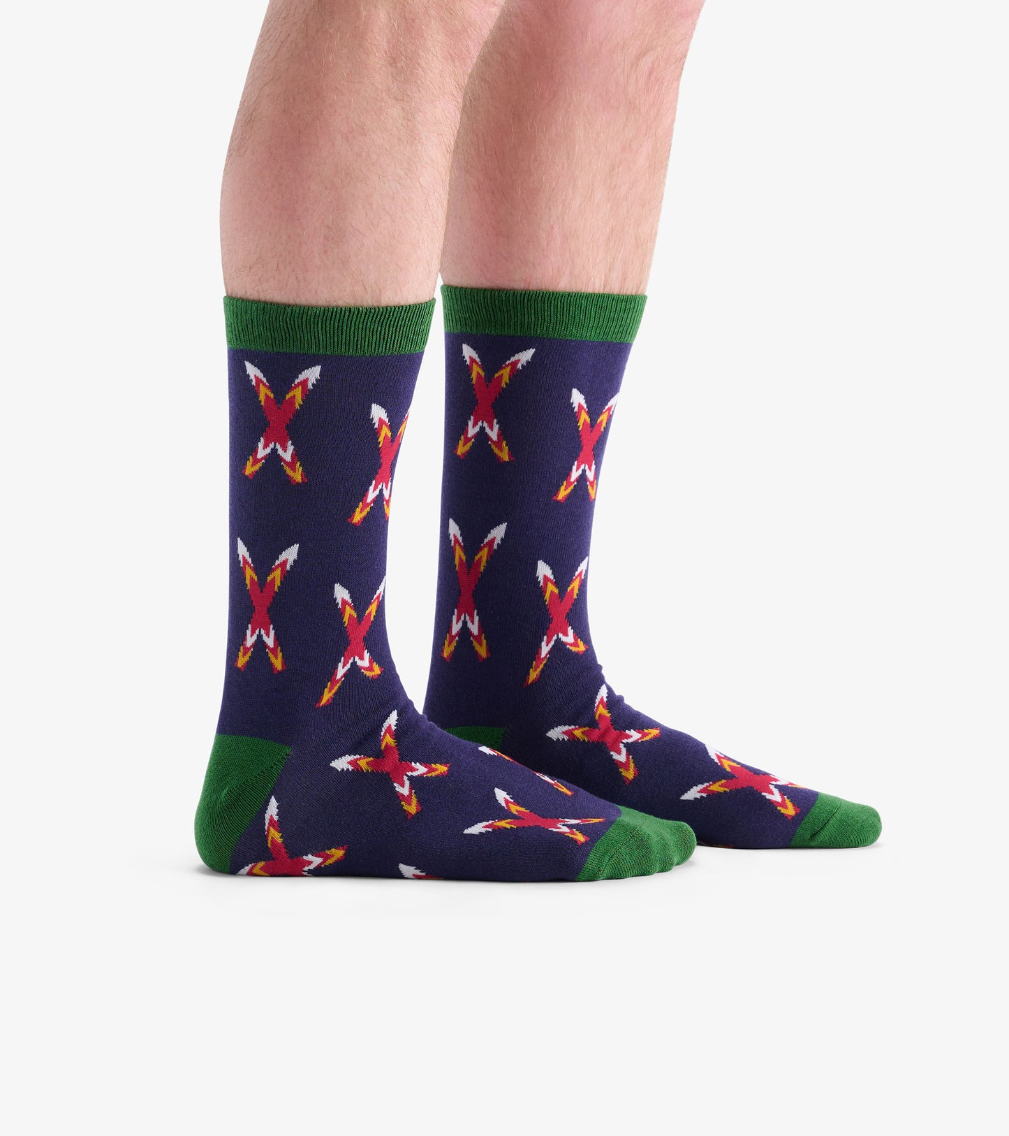 Navy socks with a crossed skis pattern in red and white, featuring green cuffs and soles, suitable for casual wear.