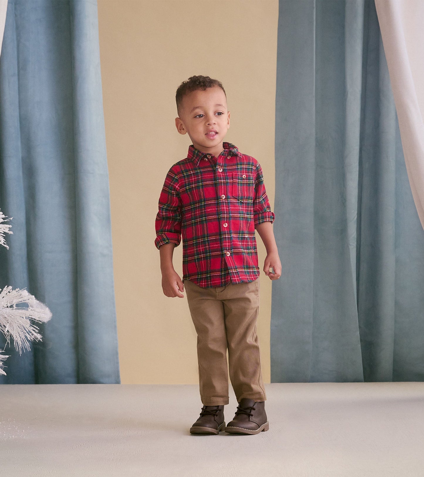 Khaki twill pants for babies, featuring a classic fit and soft fabric, paired with a plaid shirt and boots.