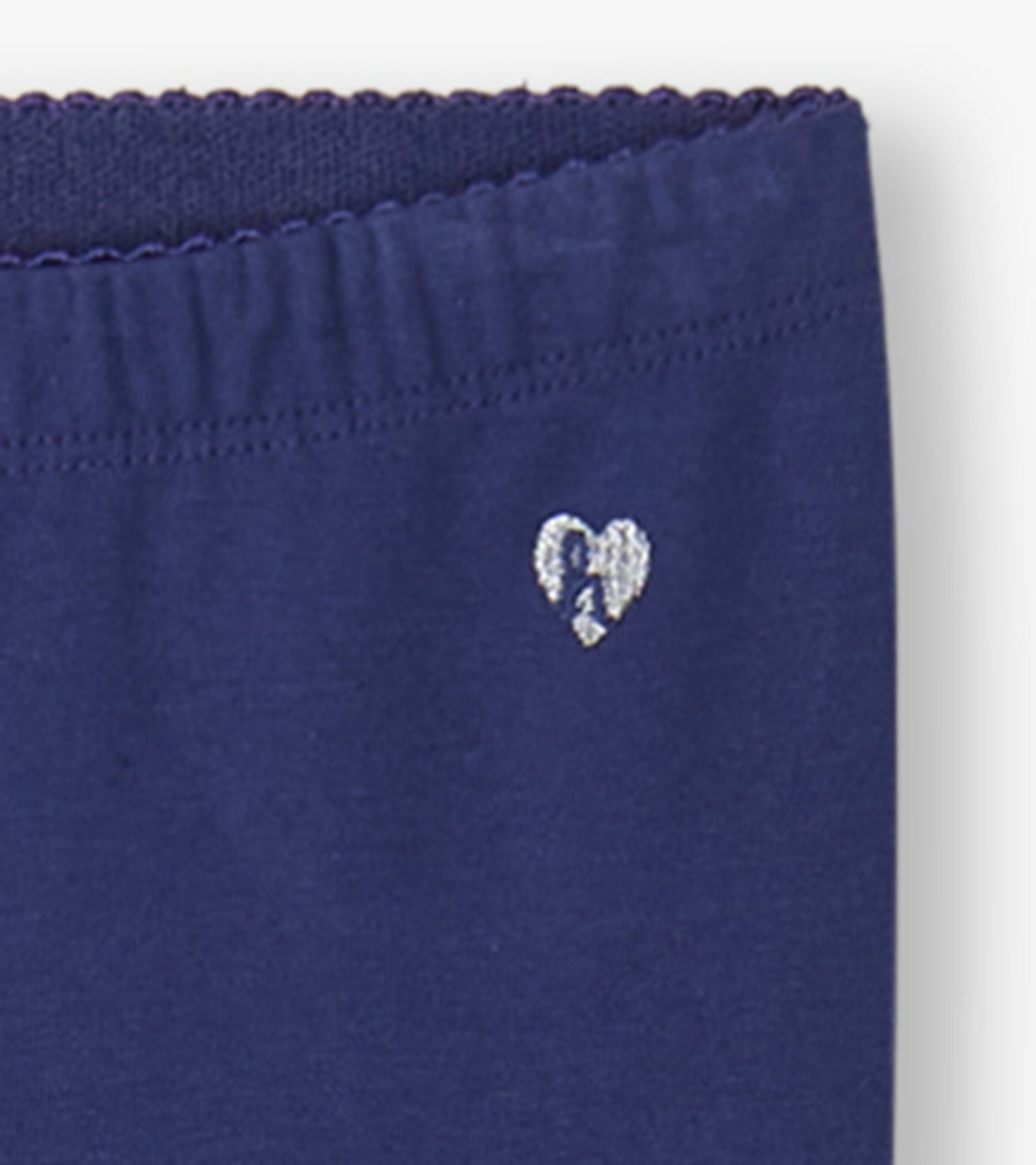 Navy leggings featuring a soft fabric and a small embroidered heart detail on the waistband.