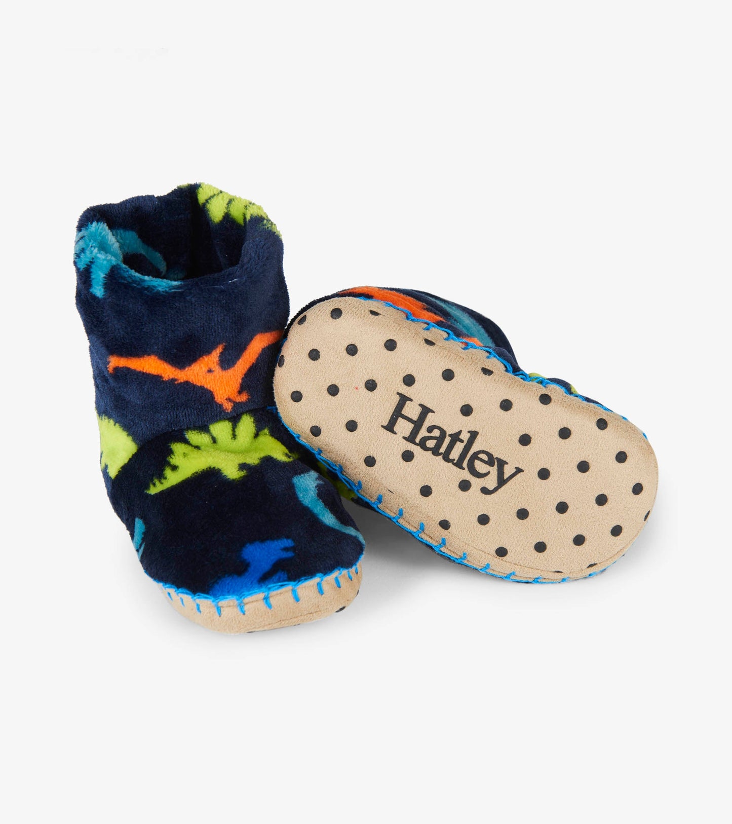 Navy fleece slippers featuring colorful dinosaur patterns and a soft, textured sole for indoor comfort.