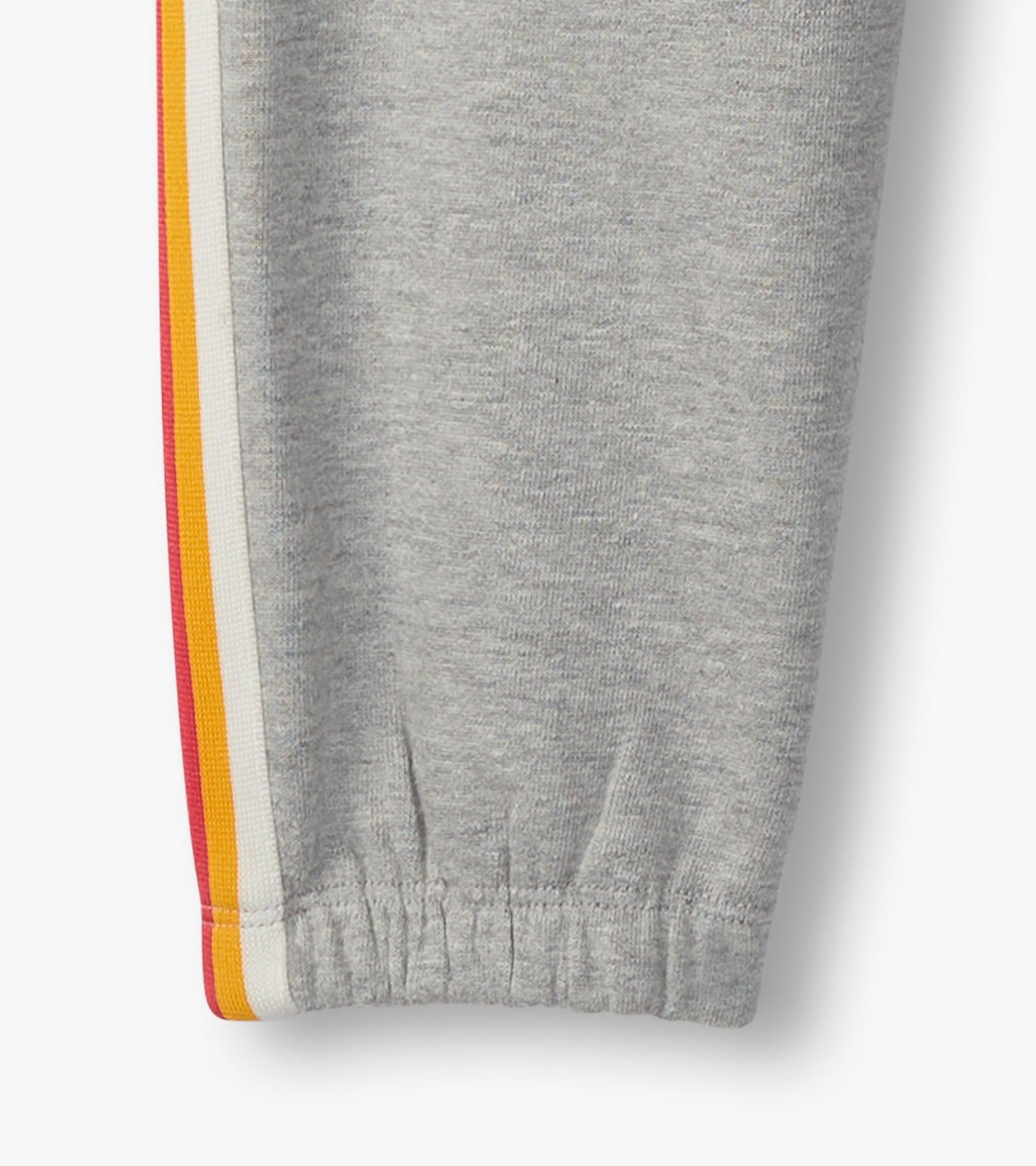 Grey baggy track pants with elastic cuffs and colorful side stripes in red, orange, and yellow.