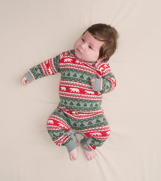 Red and green Fair Isle sweater romper featuring polar bear and tree patterns, suitable for infants.