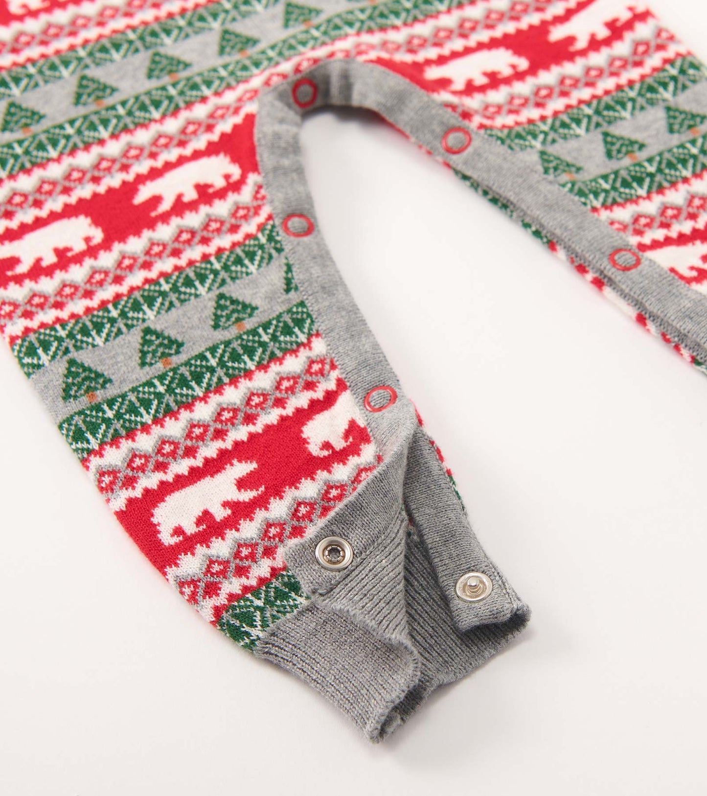 Red and green Fair Isle sweater romper with polar bear and tree patterns, featuring snap closures at the bottom.