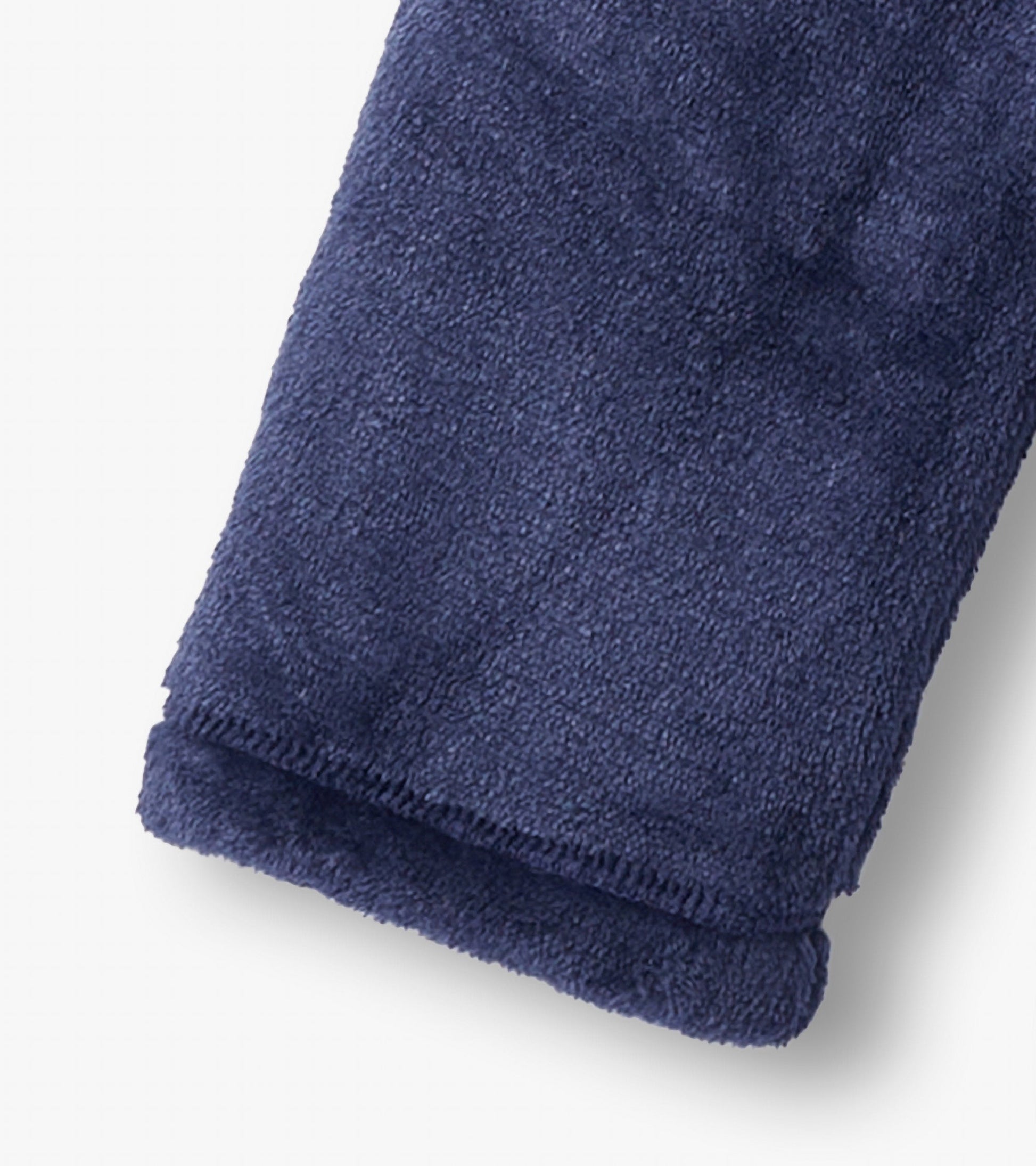 Navy fuzzy fleece fabric with a soft texture, showcasing the cuff of a zip-up jacket for girls.