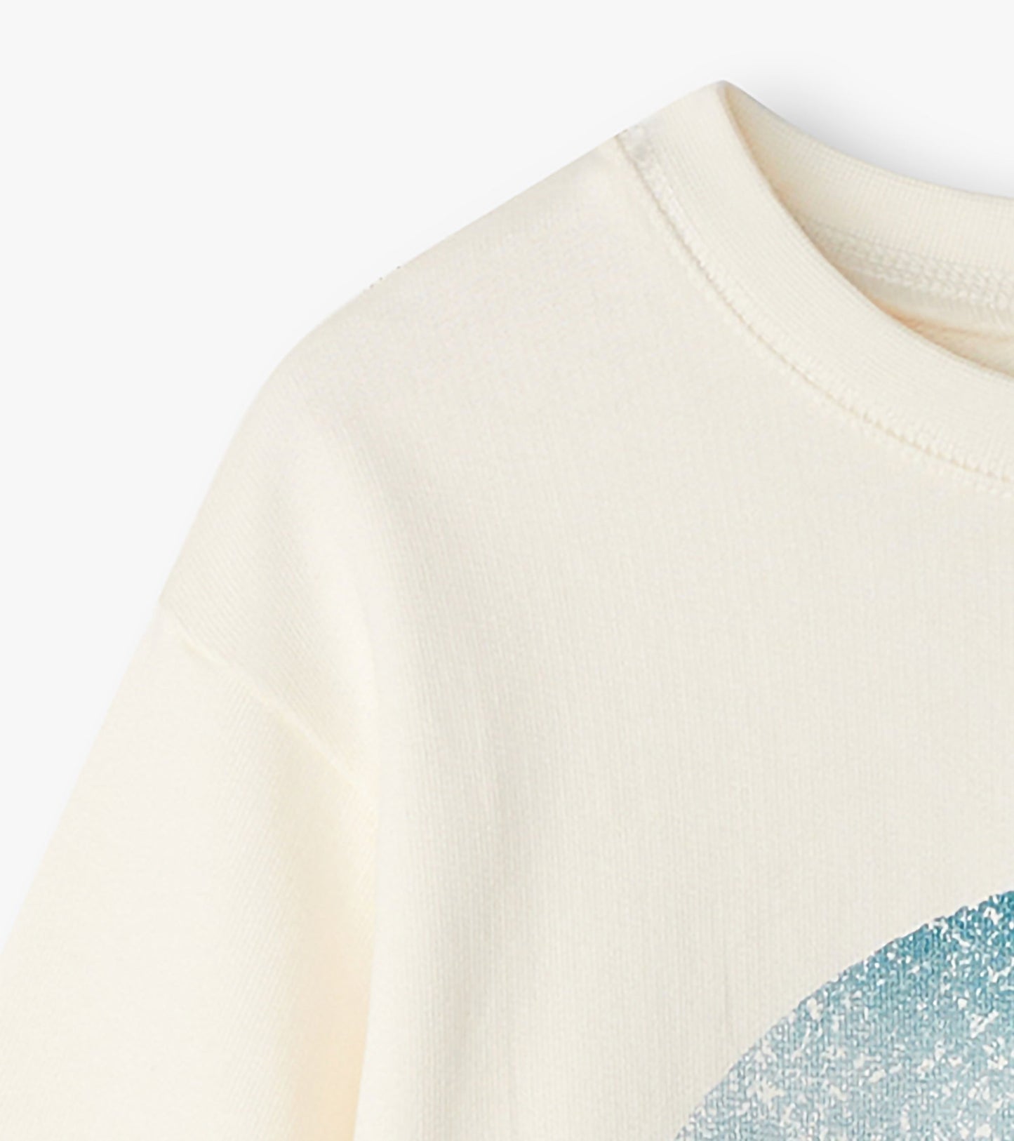 Cream-colored sweatshirt with a blue graphic print, featuring a round neckline and long sleeves.