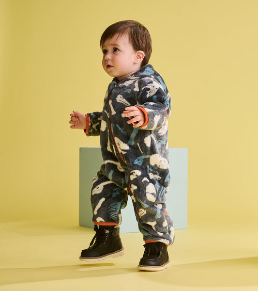 Fleece suit for baby boys featuring a dino fossil pattern in dark blue and white, with orange accents and a cozy fit.