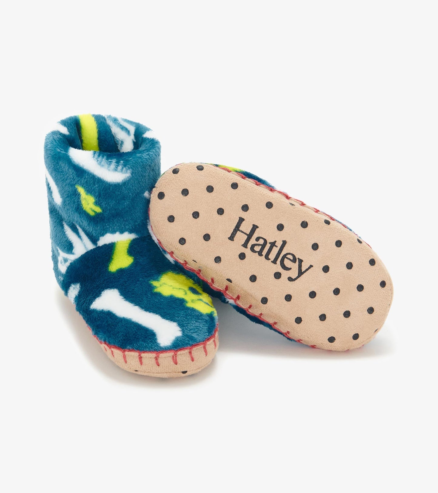 Blue fleece slippers featuring dinosaur fossils, with a soft upper and dotted sole for grip.