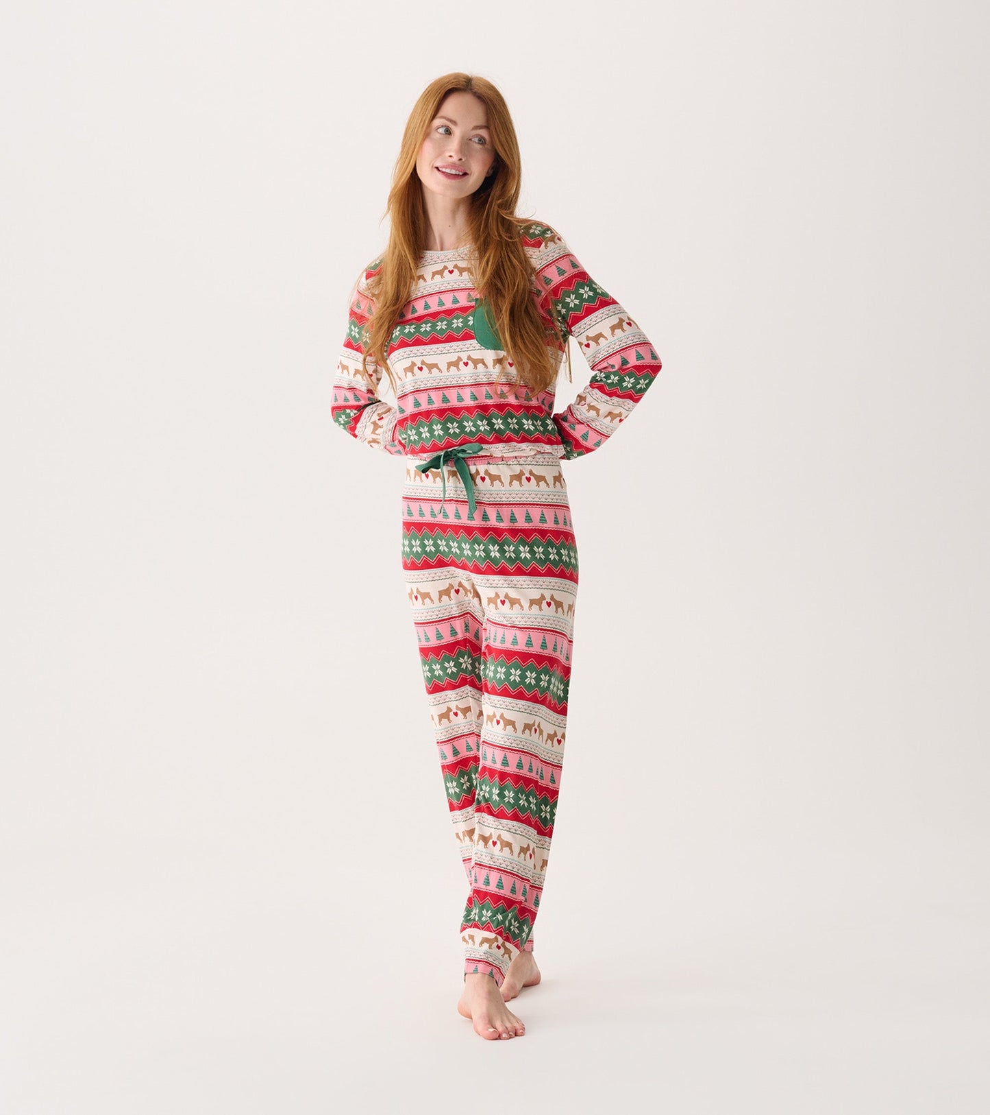 Long-sleeve pyjama set featuring a festive puppy hearts Fairisle pattern in red, green, and cream.