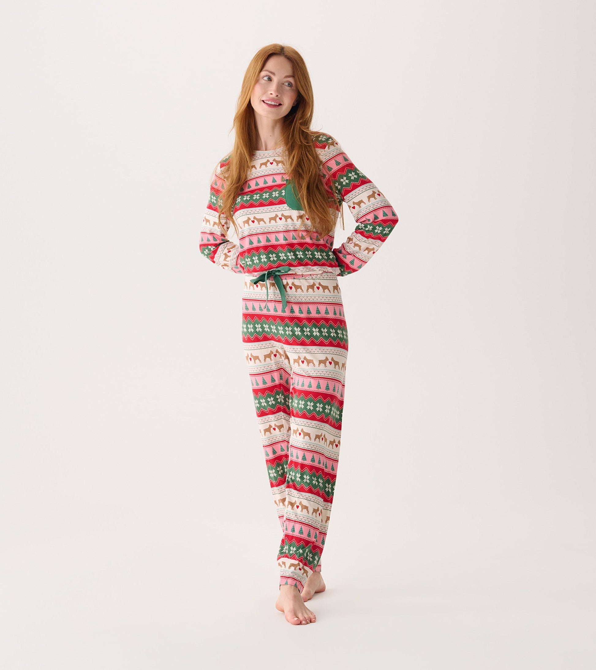 Long-sleeve pyjama set featuring a festive puppy hearts Fairisle pattern in red, green, and cream.