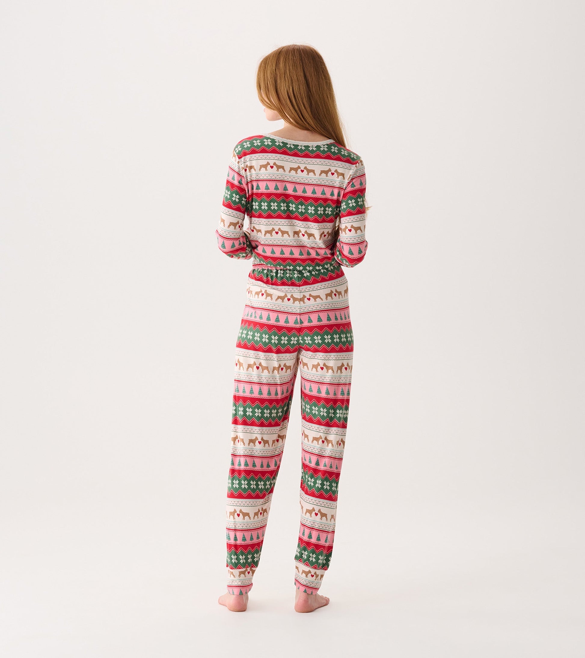 Bamboo pyjama set featuring a festive puppy hearts Fairisle pattern in pink, green, and cream, shown from the back.