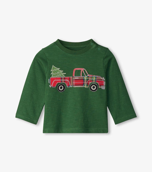 Green long sleeve t-shirt featuring a red plaid truck with a Christmas tree design on the front.