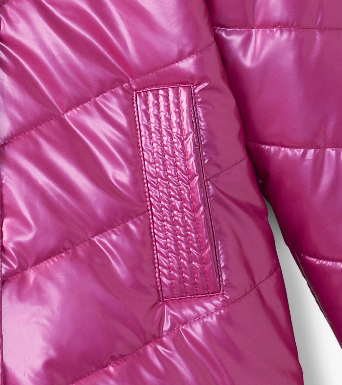 Fuschia puffer jacket featuring a quilted pattern and a textured patch on the sleeve. Suitable for girls.