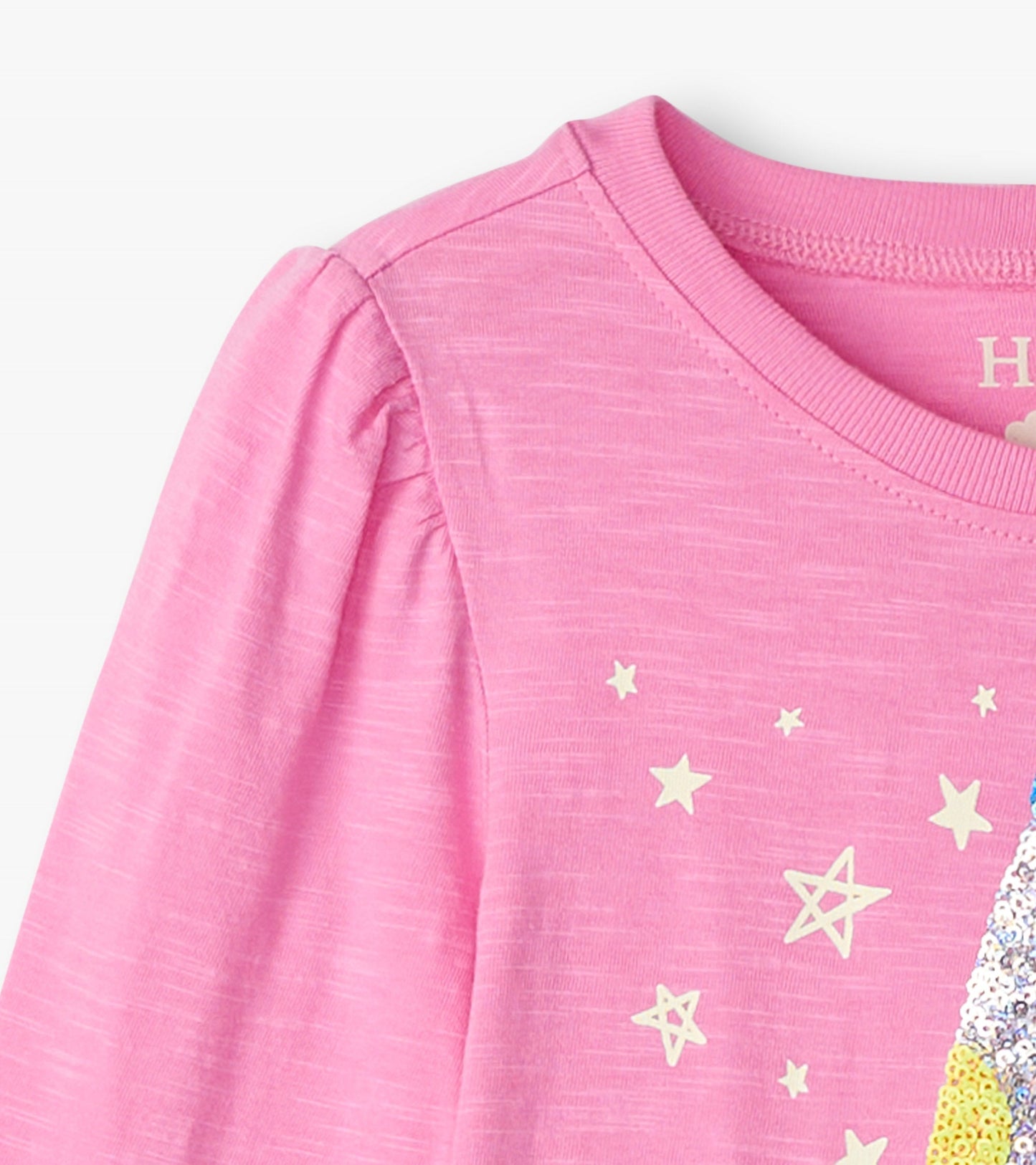 Pink long sleeve graphic tee featuring a colorful lava lamp design with stars. Soft fabric with a relaxed fit.