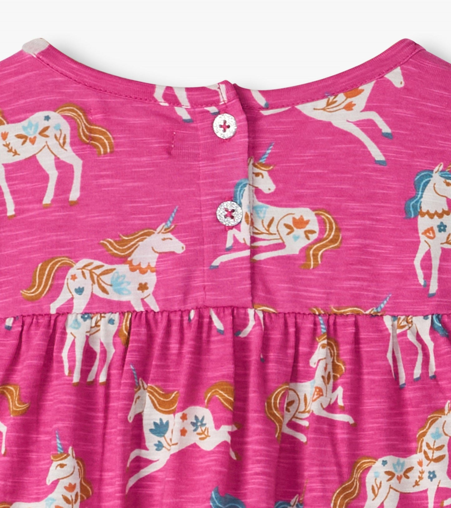 Pink gathered tiered dress featuring a whimsical unicorn print and button closure at the back.