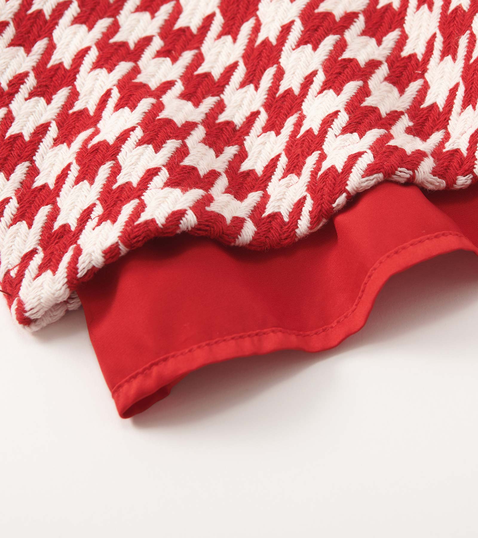 Red and white houndstooth patterned dress with a big bow detail and a solid red lining.