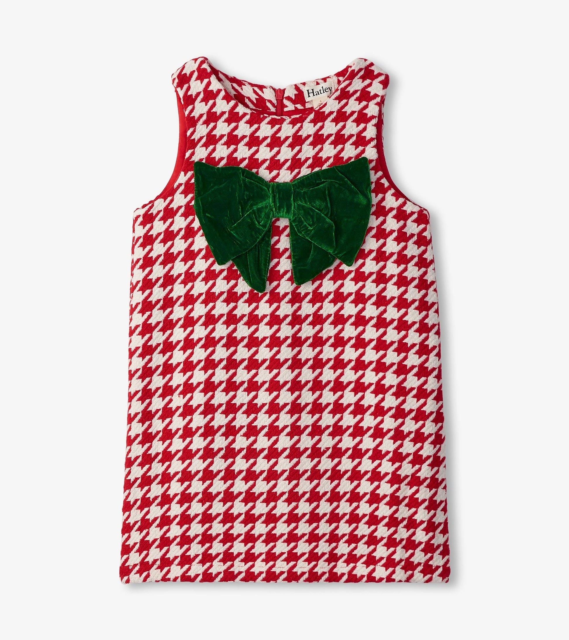 Red and white houndstooth dress with a large green velvet bow on the front, sleeveless design.