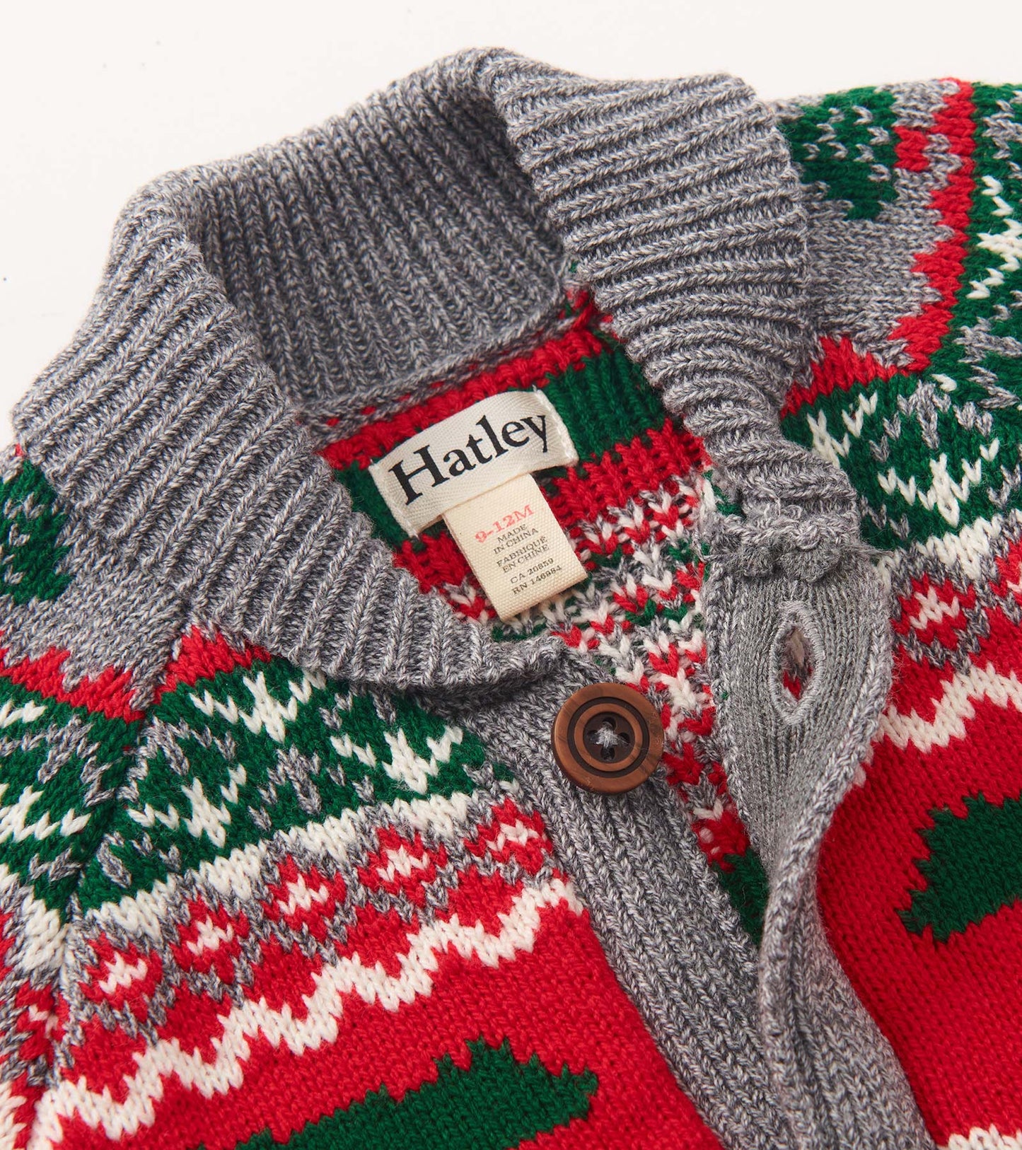 Knit cardigan with a shawl collar, featuring a festive red, green, and gray pattern, suitable for babies and toddlers.