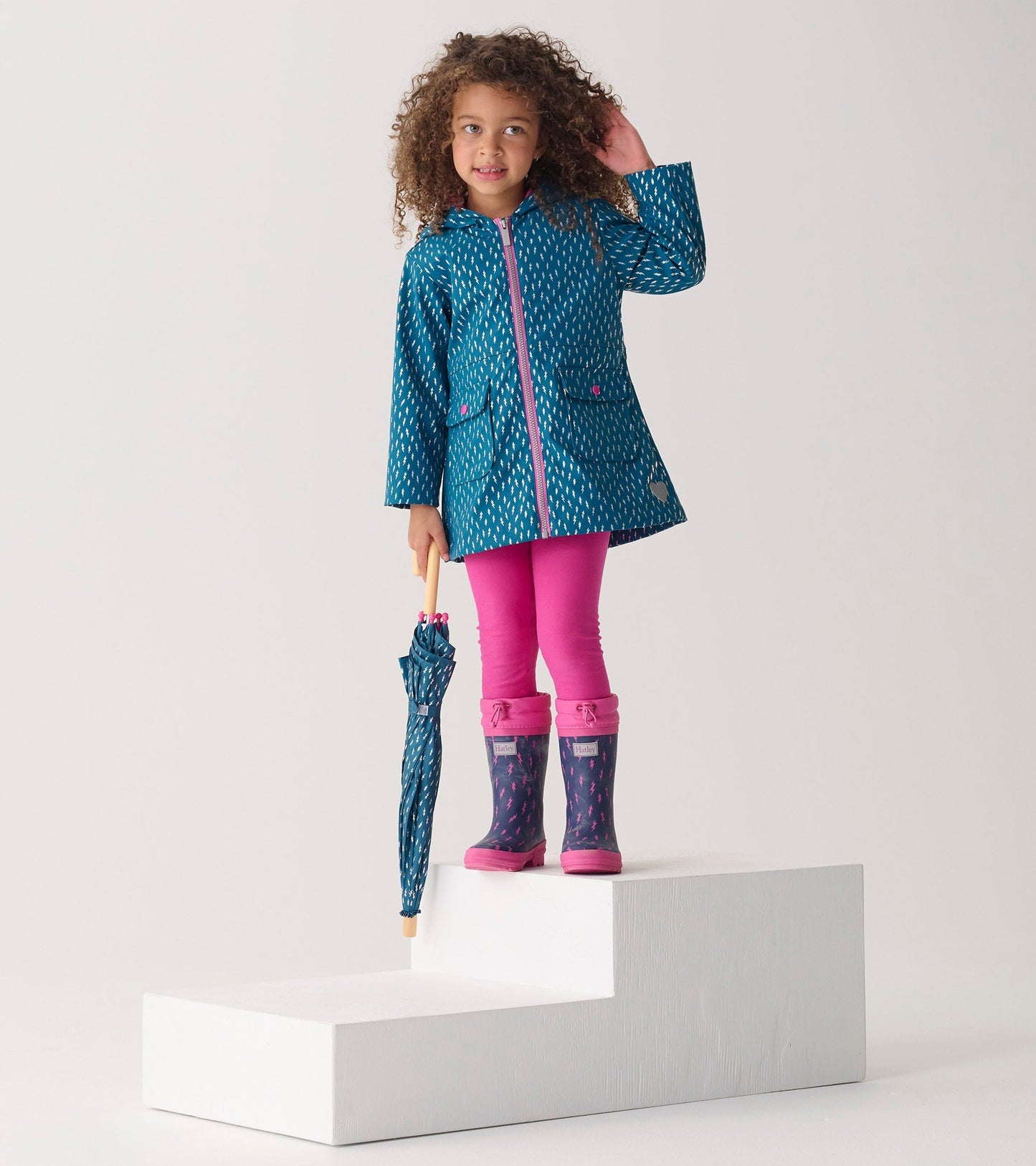 Sherpa-lined wellies in purple with pink accents, featuring a lightning bolt pattern, perfect for rainy days.