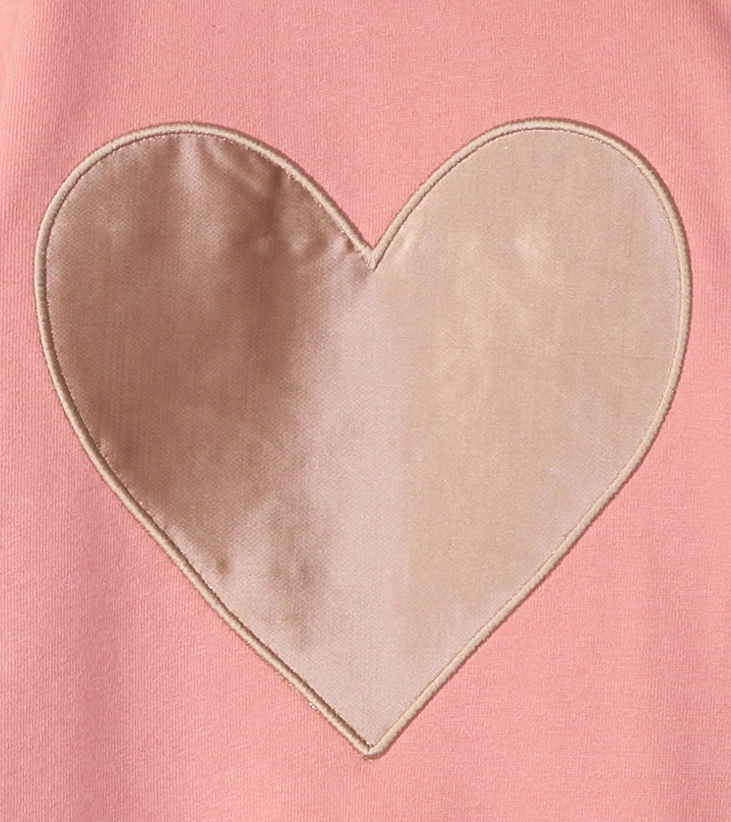 Pink dress featuring a large beige satin heart appliqué on the front. Soft fabric ideal for baby and toddler girls.
