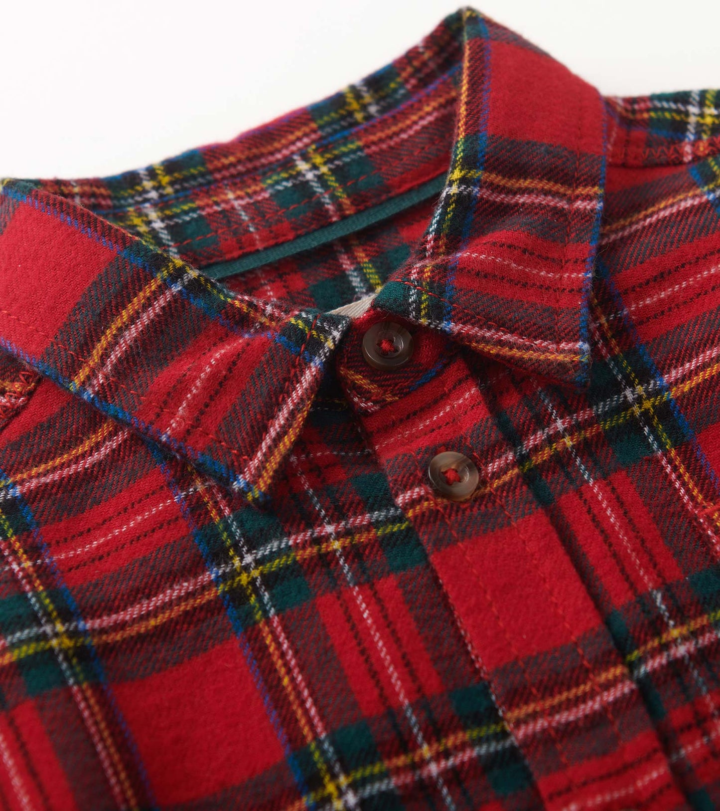 Red plaid button-down shirt with a collar and button closure, featuring green, yellow, and white accents.