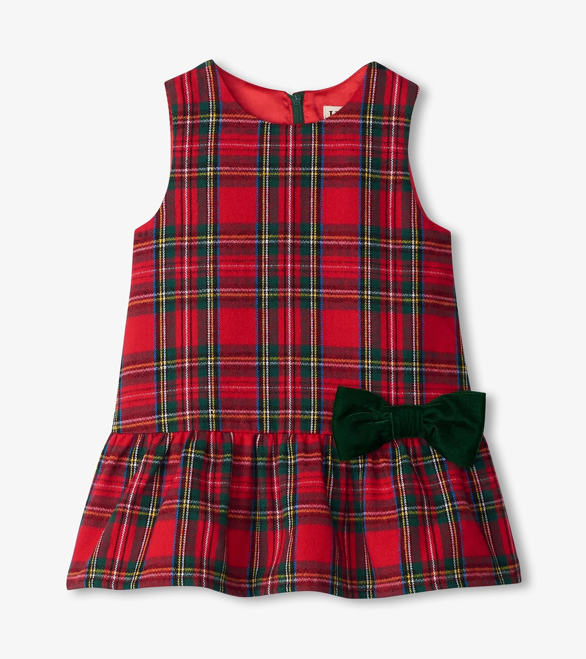 Red plaid pinafore dress with a flared skirt and green bow detail, designed for babies and toddlers.