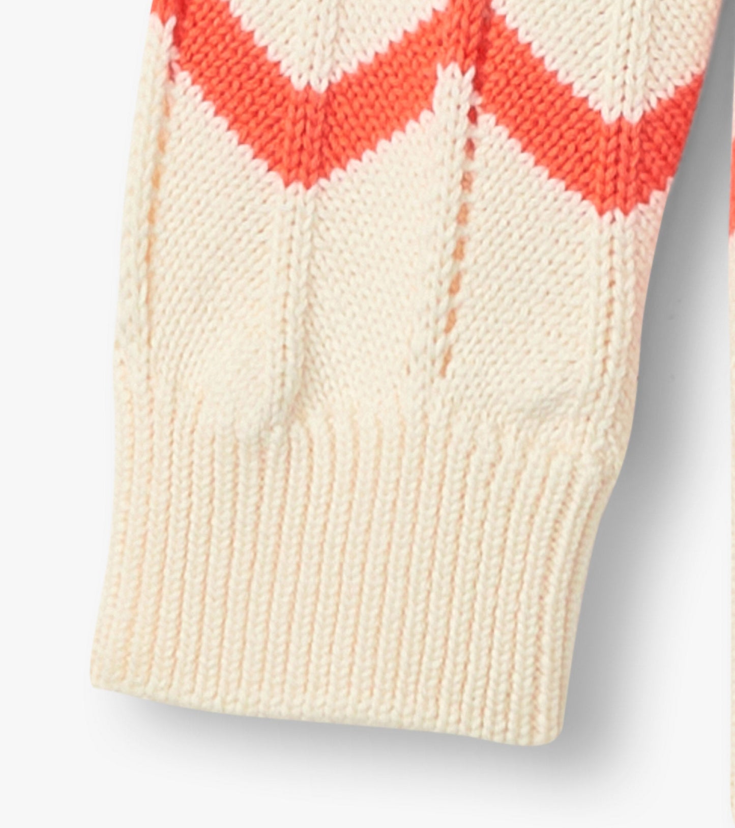 Cream sweater featuring a colorful chevron pattern in coral and pink, with ribbed cuffs for a snug fit.