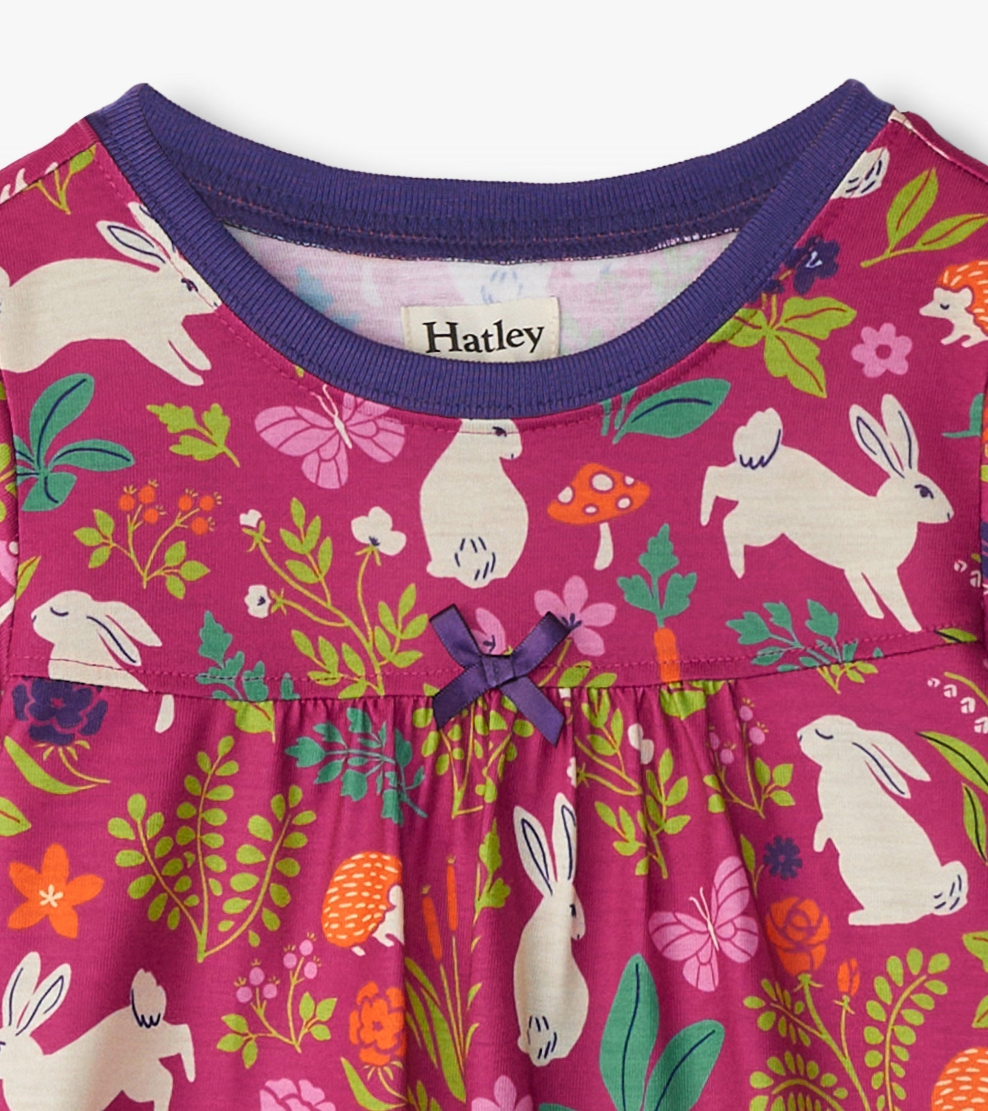 Purple nightgown featuring a playful bunny and floral pattern, with a gathered waist and a small bow detail.