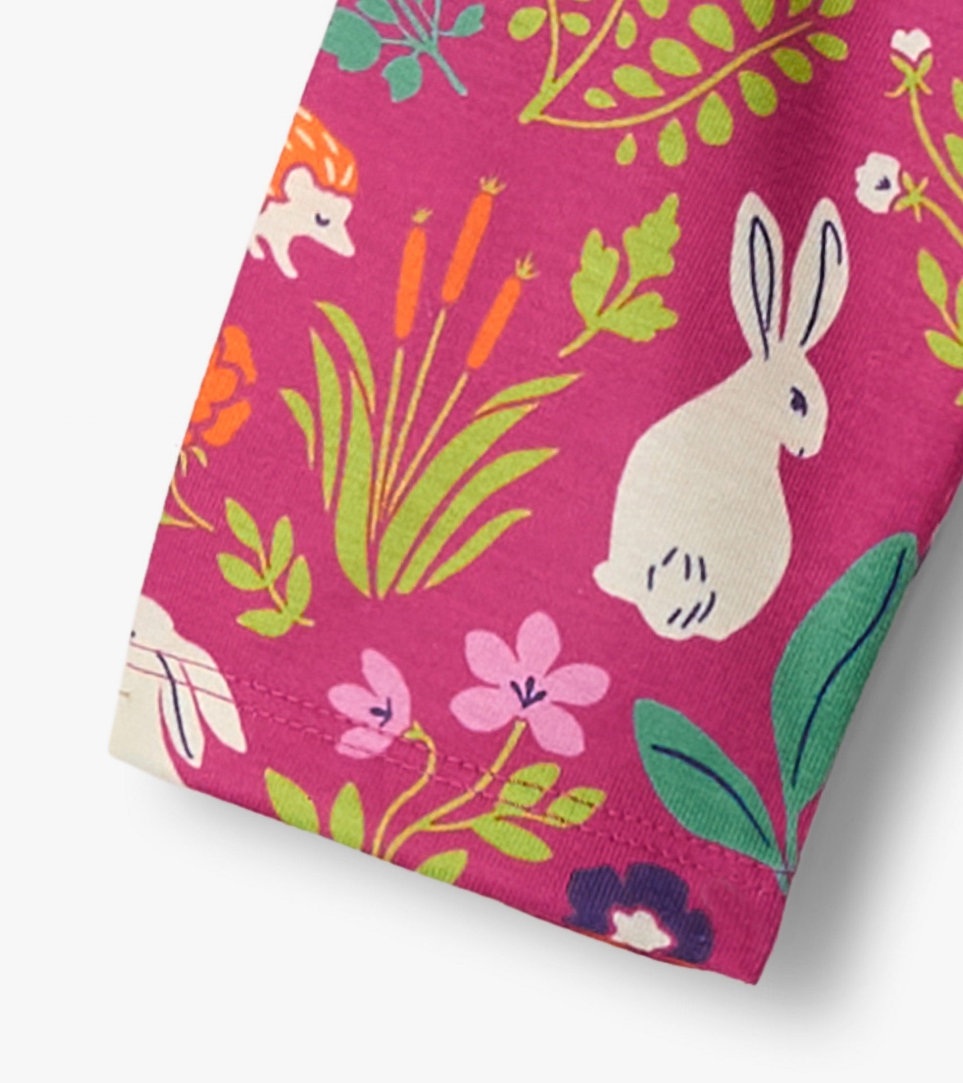 Pink nightgown featuring a playful bunny and floral pattern, made from soft fabric, ideal for sleepwear.