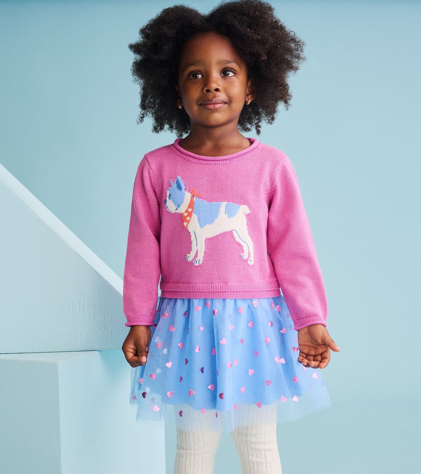 Pink sweater dress with a French bulldog design, layered tulle skirt in blue with heart patterns, suitable for toddlers.