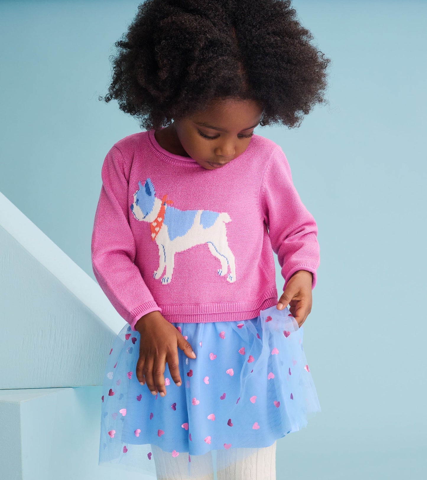 Pink sweater dress with a French bulldog design and a blue tulle skirt featuring heart patterns.