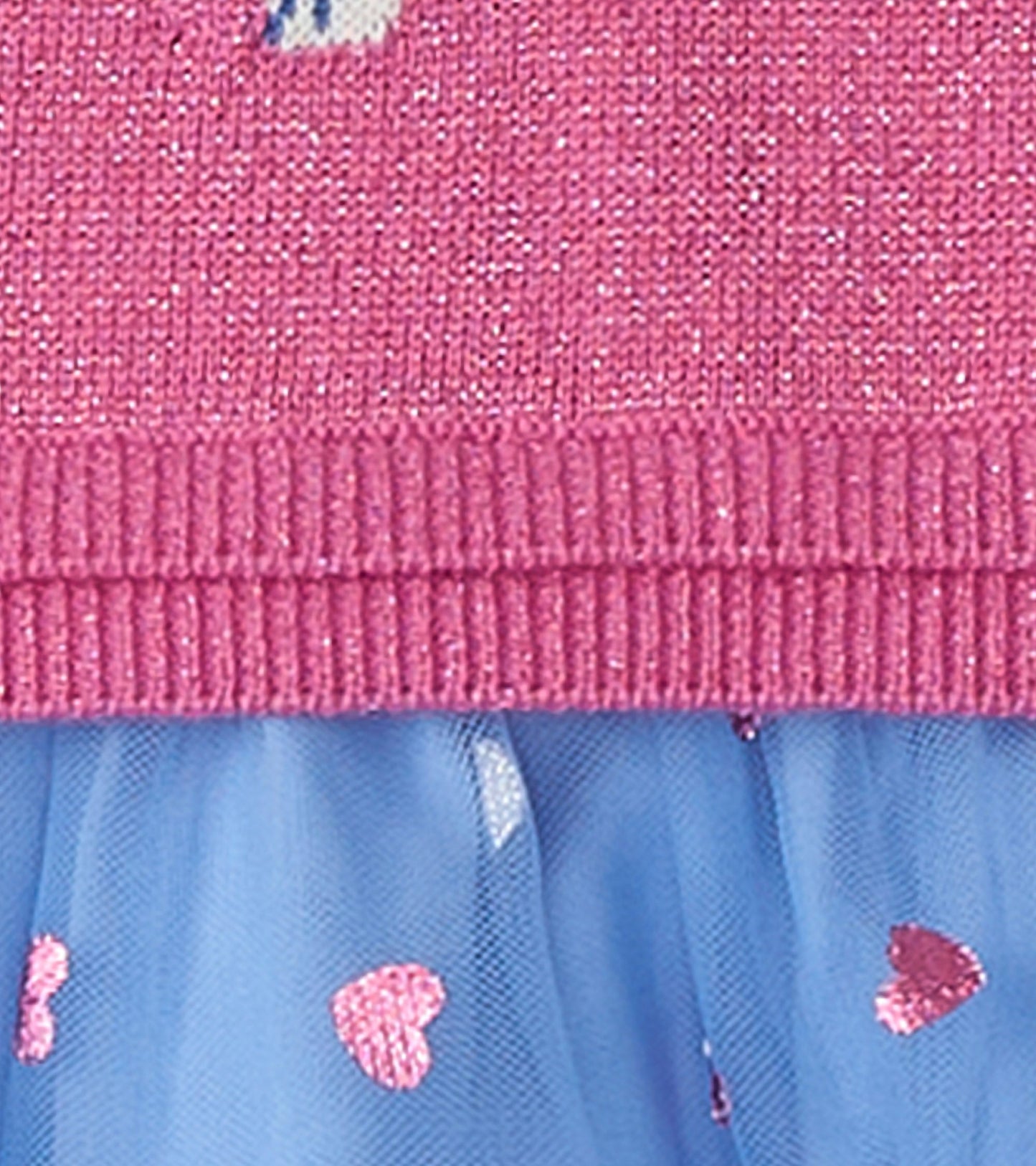 Pink knitted top with French bulldog design, layered with a blue tulle skirt featuring pink heart patterns.