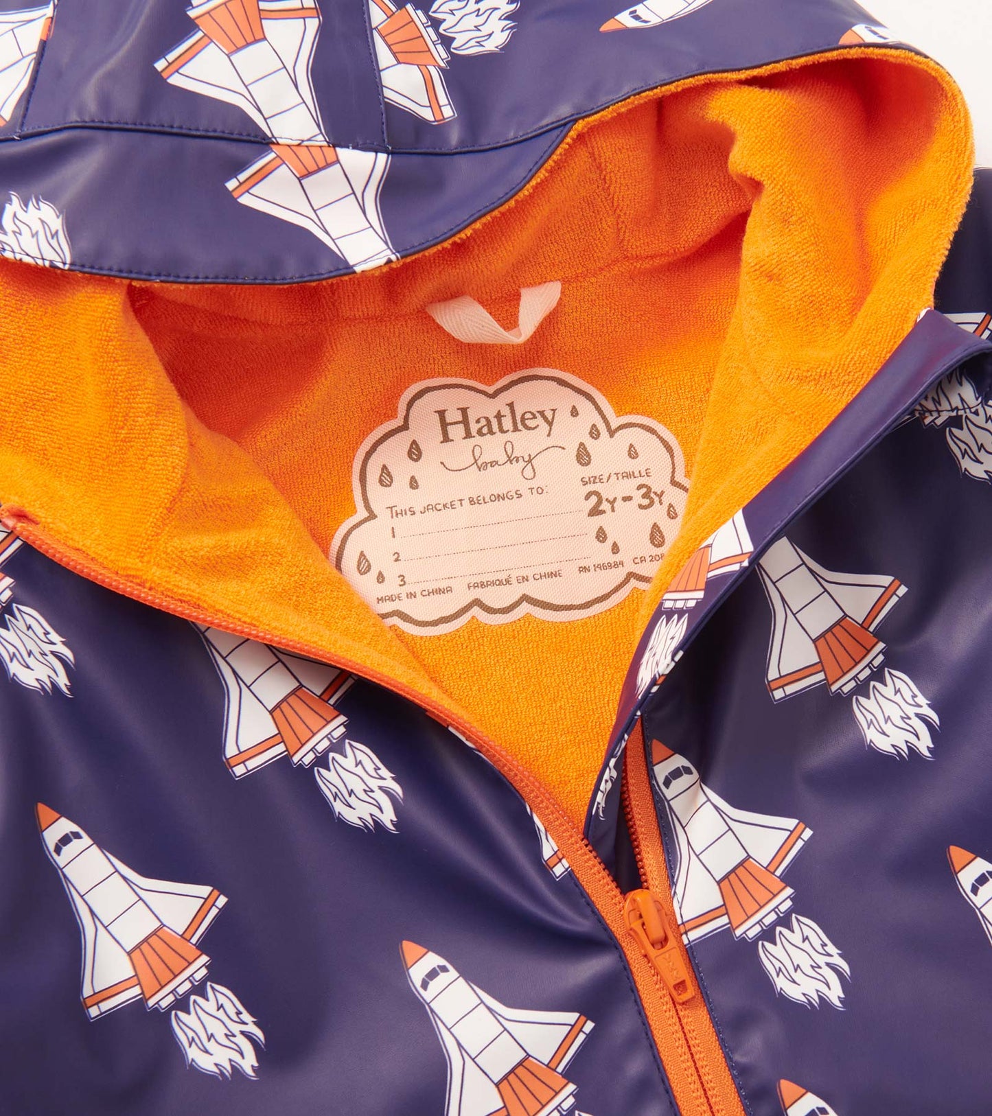 Navy rain suit featuring colorful space shuttle prints and an orange fleece lining, designed for baby boys.