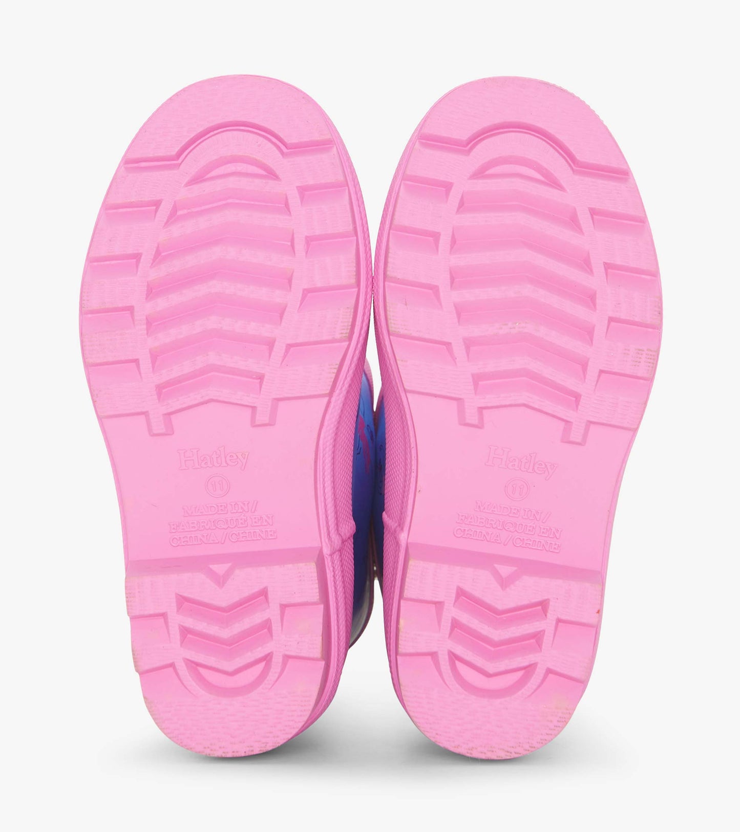Pink rubber soles of girls' ballet school wellies with textured grip pattern.