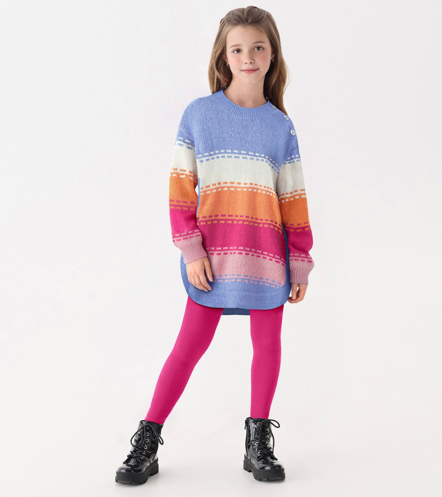 Chunky sweater tunic in blue with colorful horizontal stripes, paired with pink leggings and black boots.