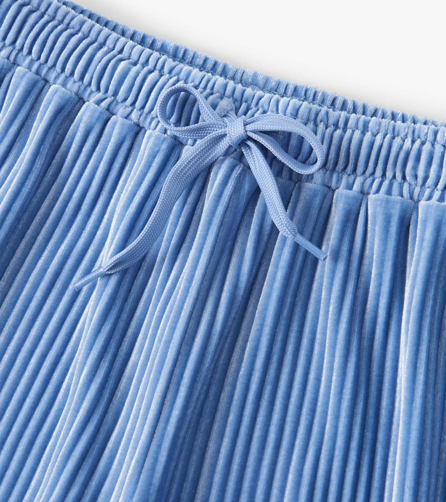 Cornflower blue pleated velour pants with an elastic waistband and drawstring detail.