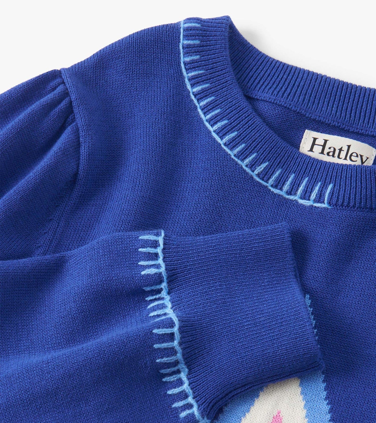 Blue pullover sweater with a textured neckline and cuffs, featuring a colorful design on the front.