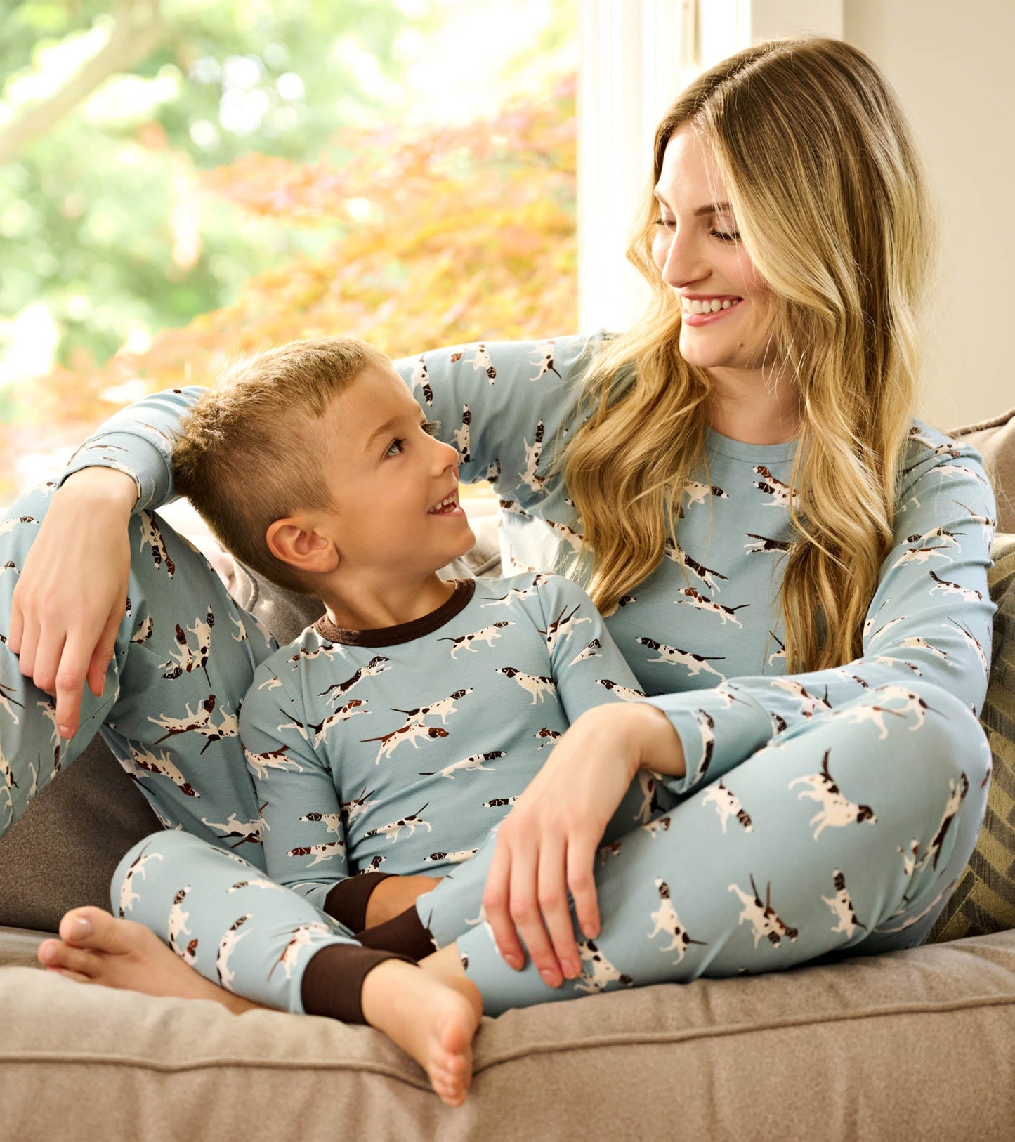 Light blue bamboo pyjama set featuring hunting dog prints, suitable for boys, shown on a child and adult.