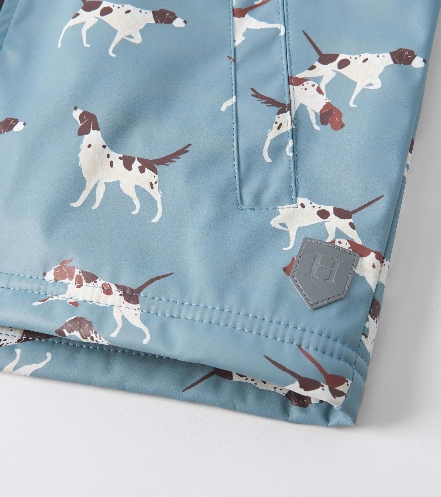 Light blue raincoat featuring a playful hunting dog pattern, with a Sherpa lining and zip-up front.