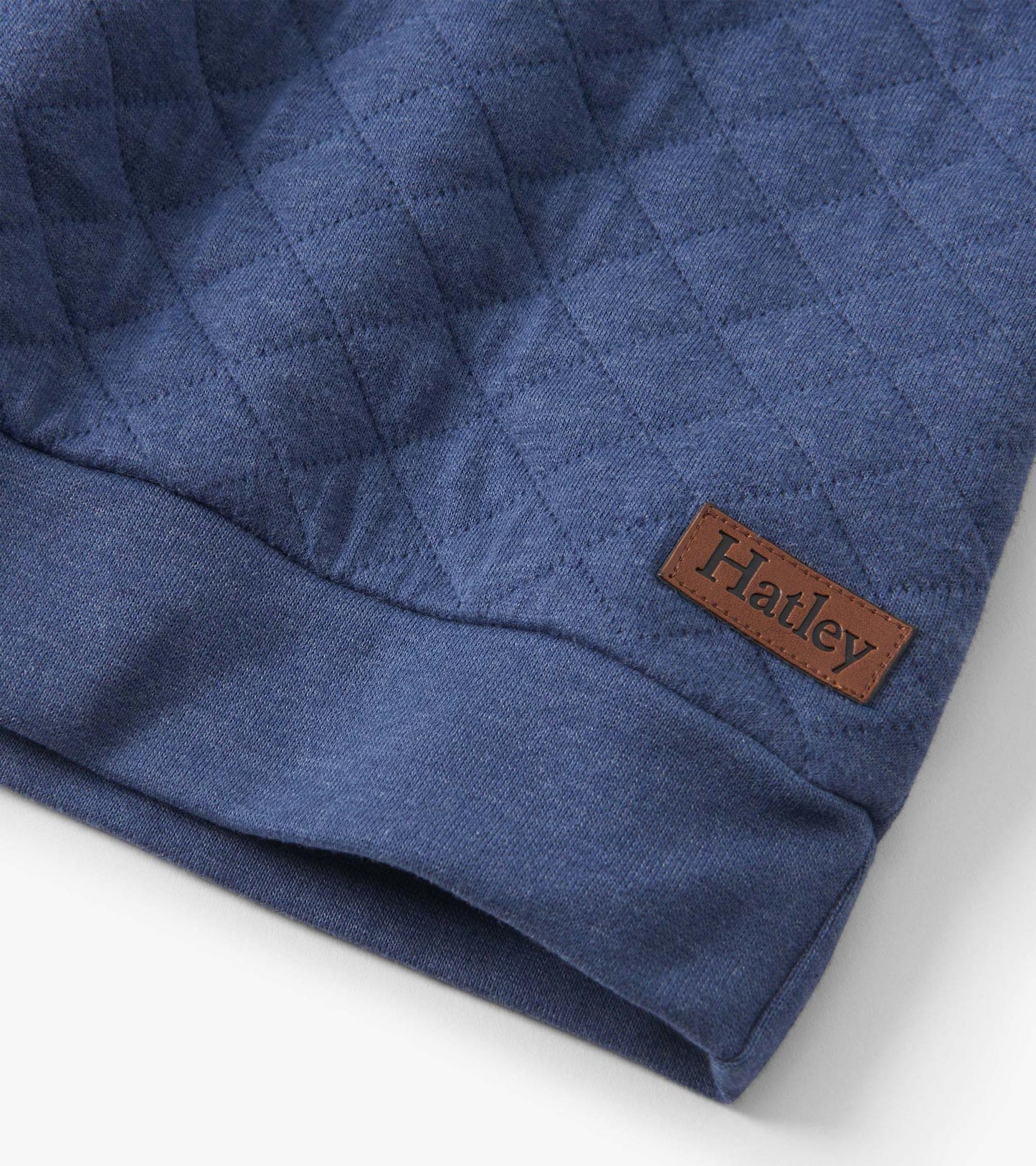 Ensign blue quilted pullover with a textured pattern and a brown leather tag. Soft fabric suitable for casual wear.