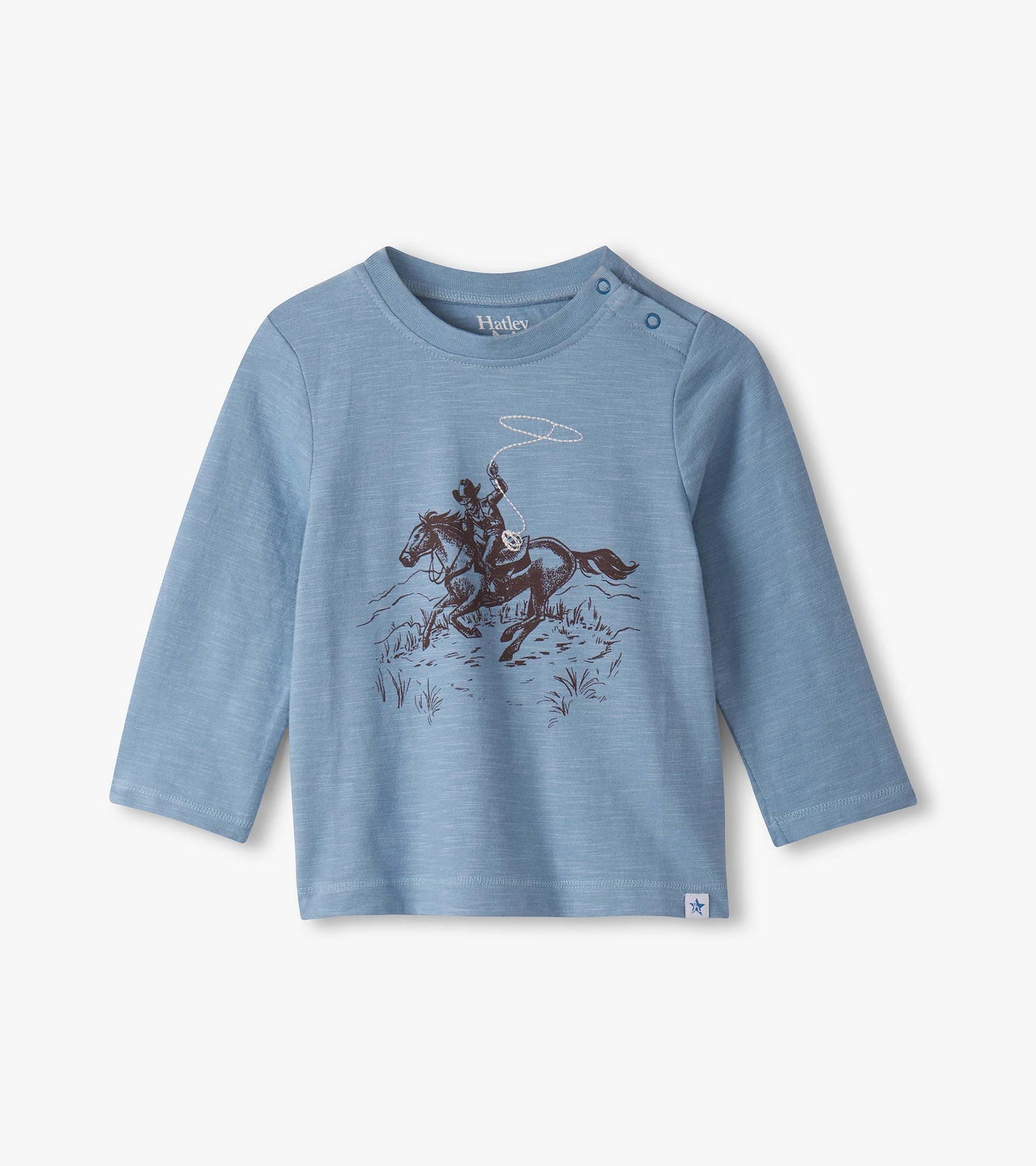 Light blue long-sleeve top featuring a cowboy on a horse graphic, with snap buttons at the shoulder for easy dressing.