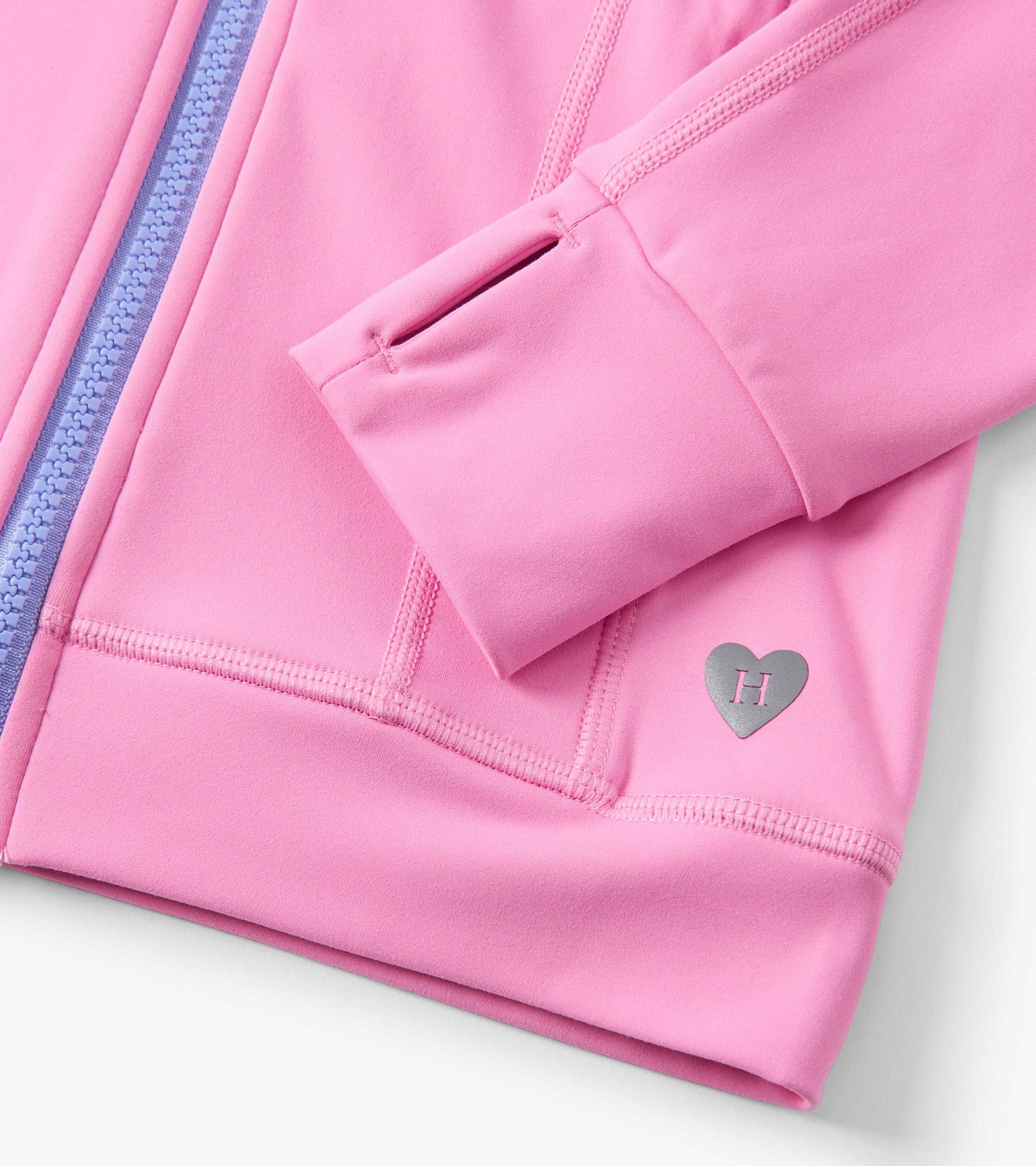 Fuchsia pink active jacket with a zip closure, featuring a silver heart logo and contrasting purple zipper.