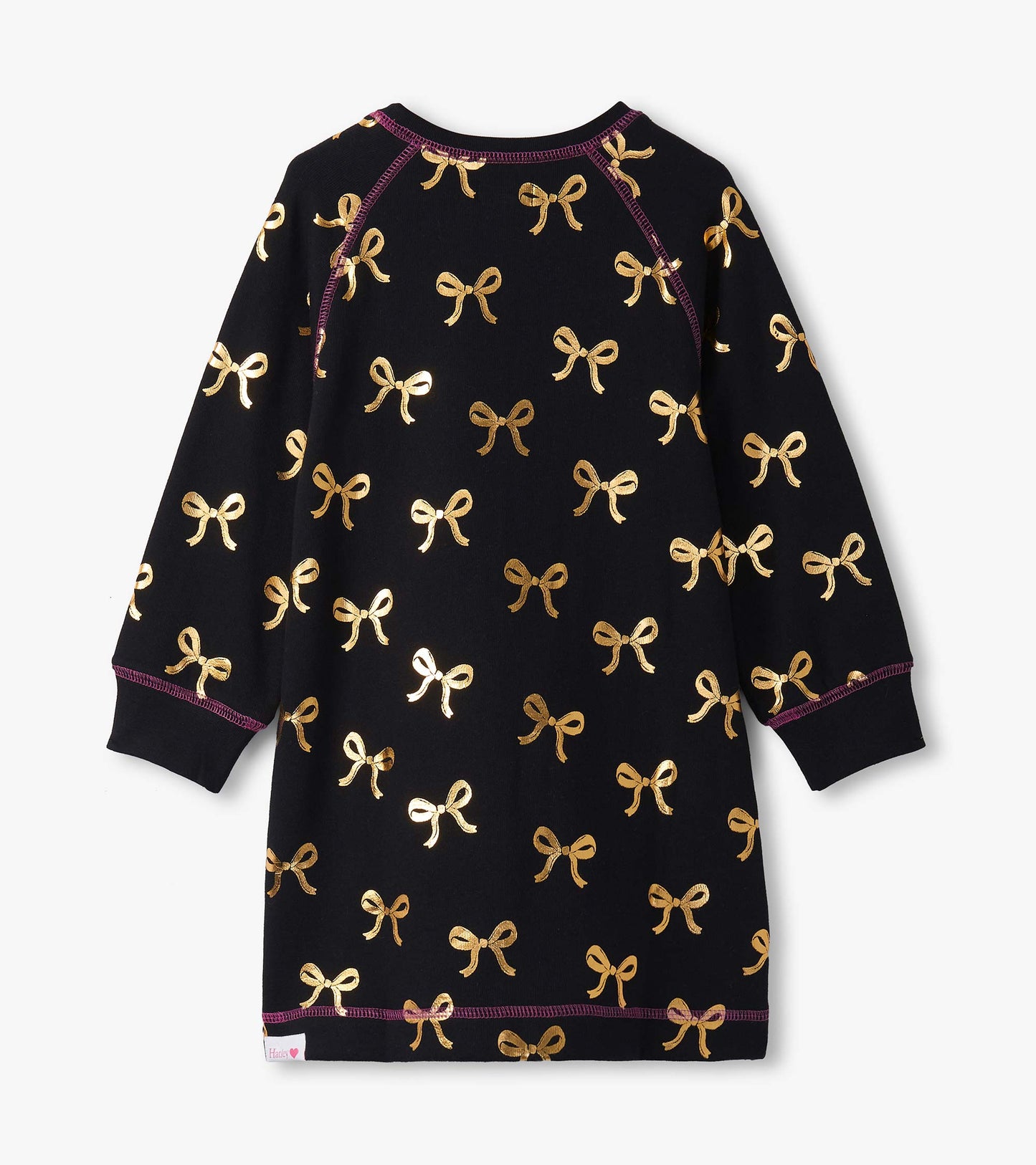 Black sweater dress featuring a gold bow pattern and long sleeves, with contrasting purple stitching.