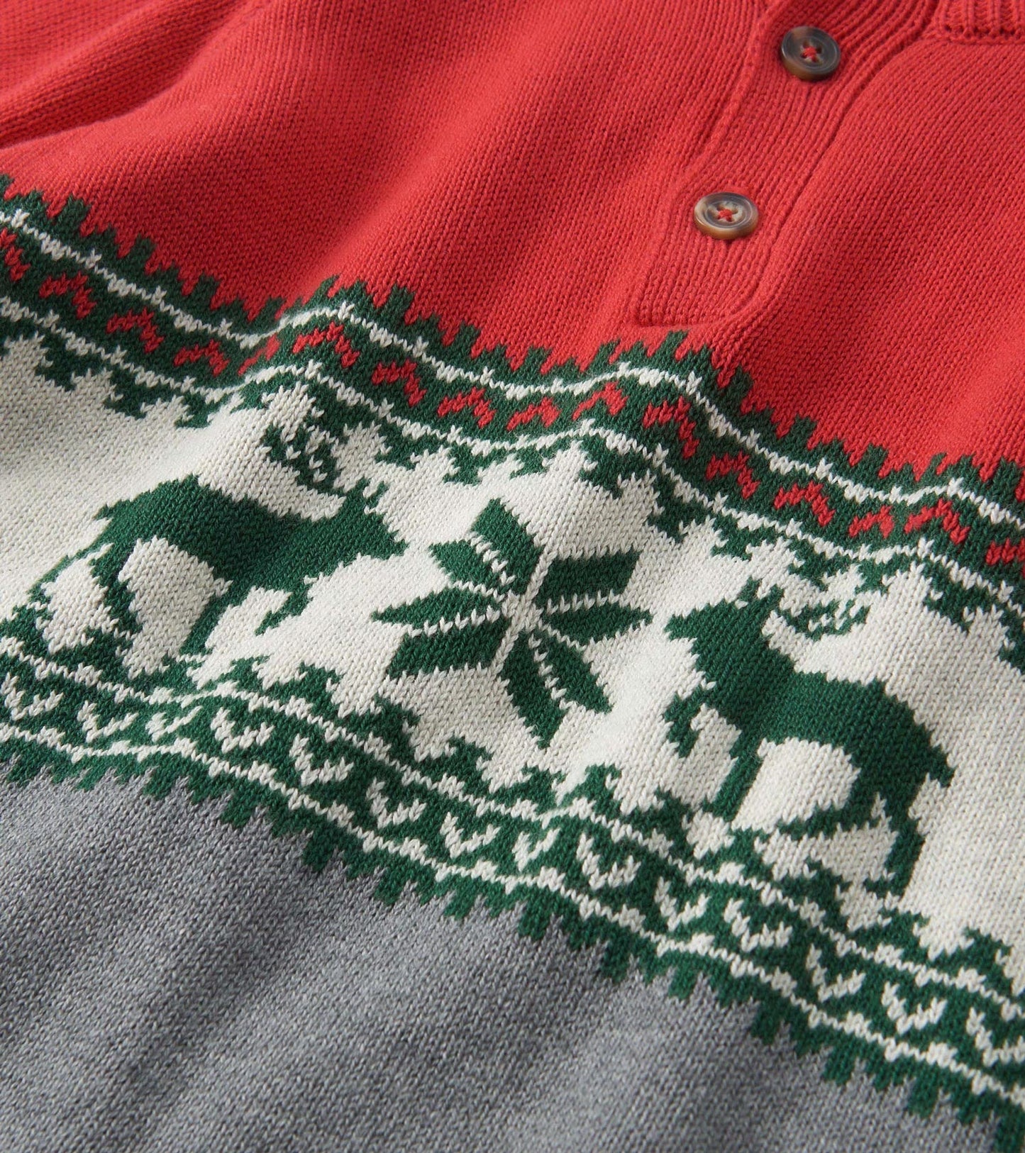 Red and gray mockneck sweater featuring a festive elk and snowflake pattern in green and white.