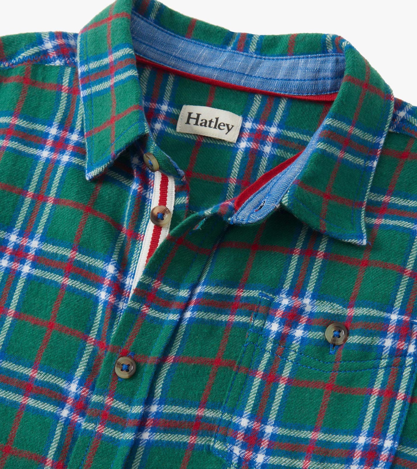 Green plaid button-down shirt featuring blue, red, and white accents, with a collar and button closure.