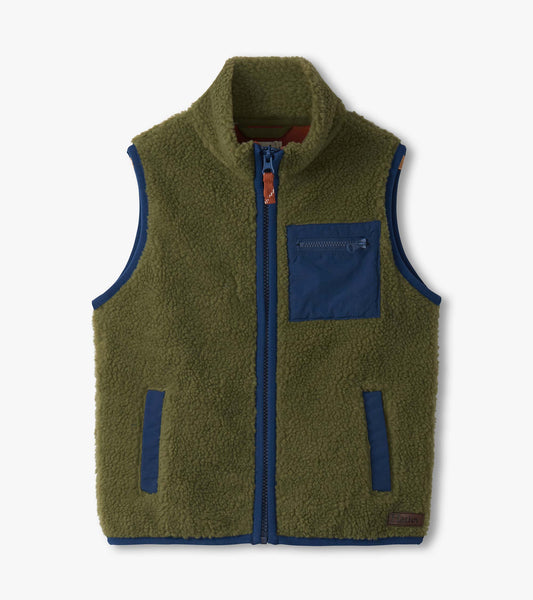 Loden green faux sherpa vest with a zip front, high collar, and navy accents, featuring a chest pocket and side pockets.