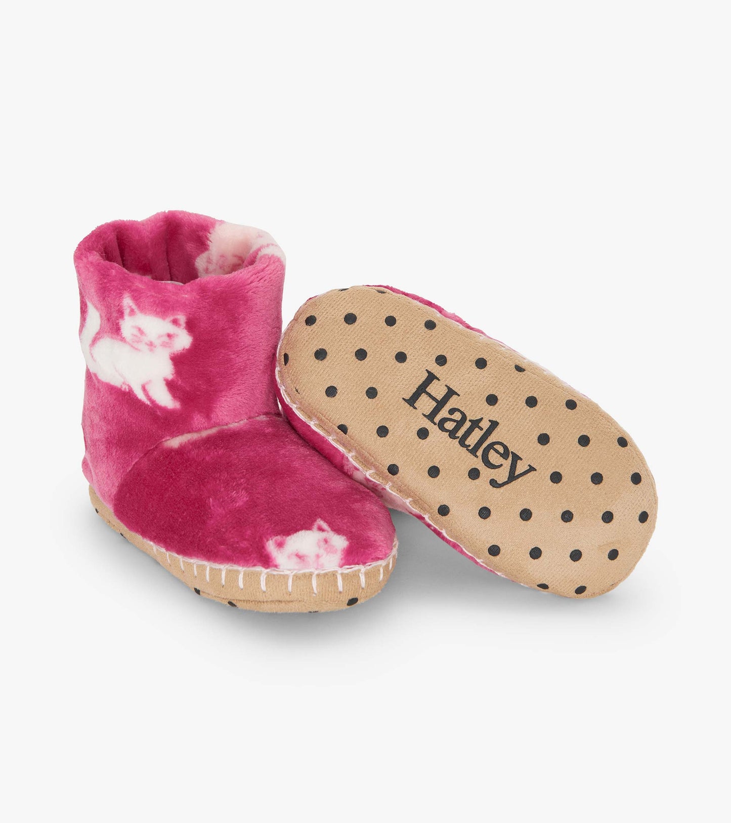 Pink fuzzy fleece slippers featuring a kitty pattern and a polka dot sole, ideal for keeping feet warm and cozy.