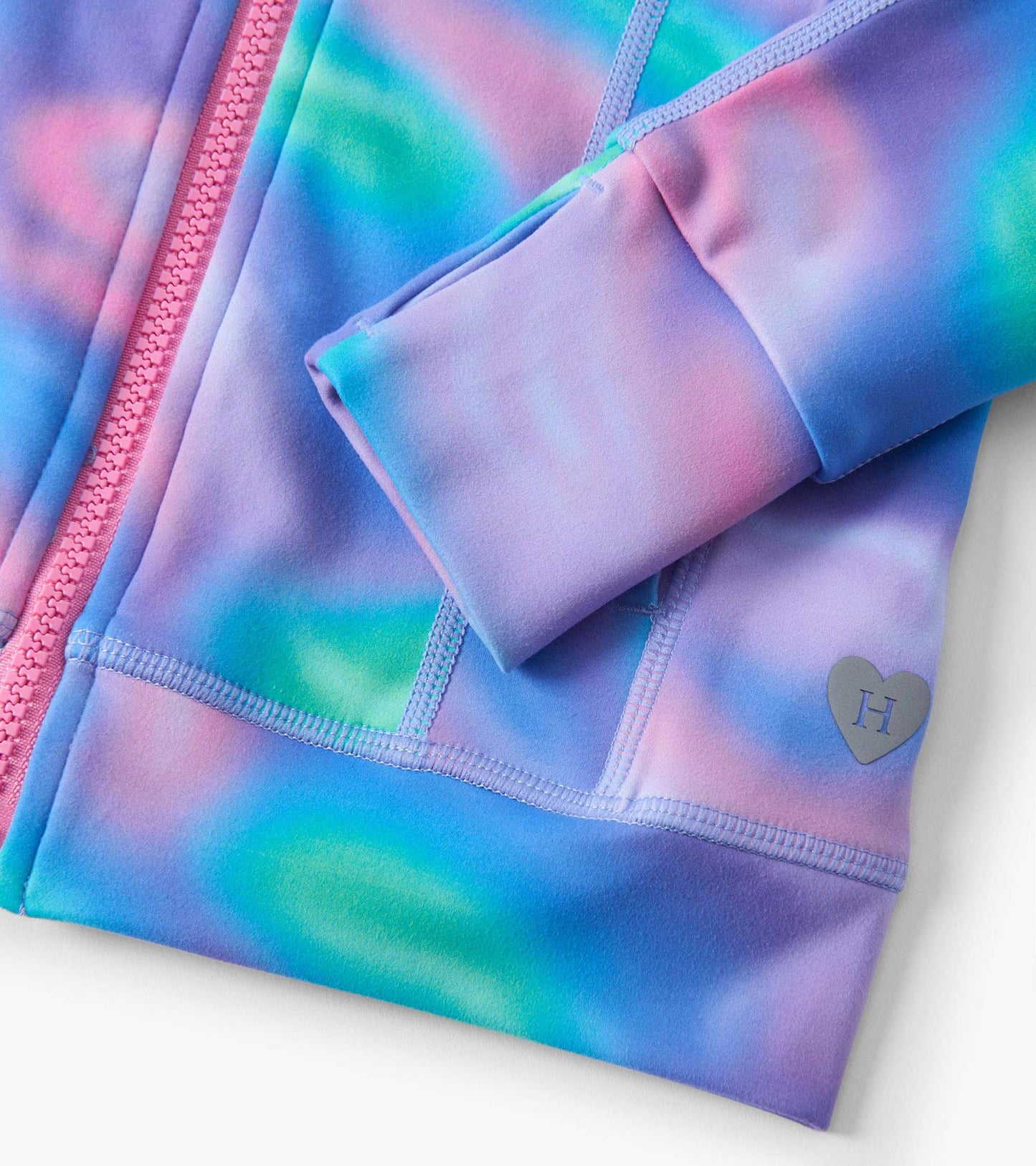 Multicolored active jacket featuring a soft fabric, zip closure, and heart logo detail on the sleeve.