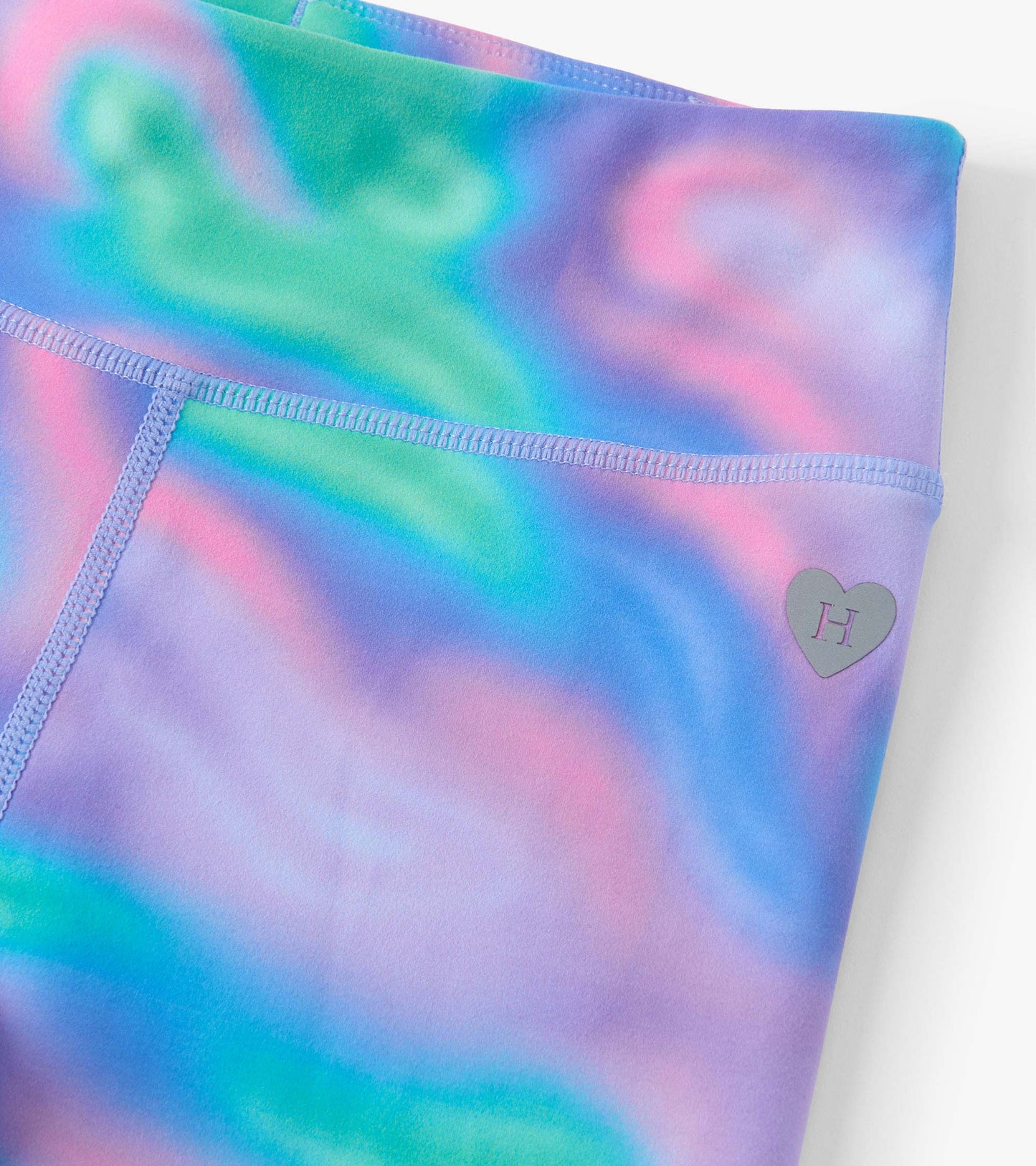 Colorful leggings featuring a swirling lava lamp pattern in shades of purple, blue, green, and pink.
