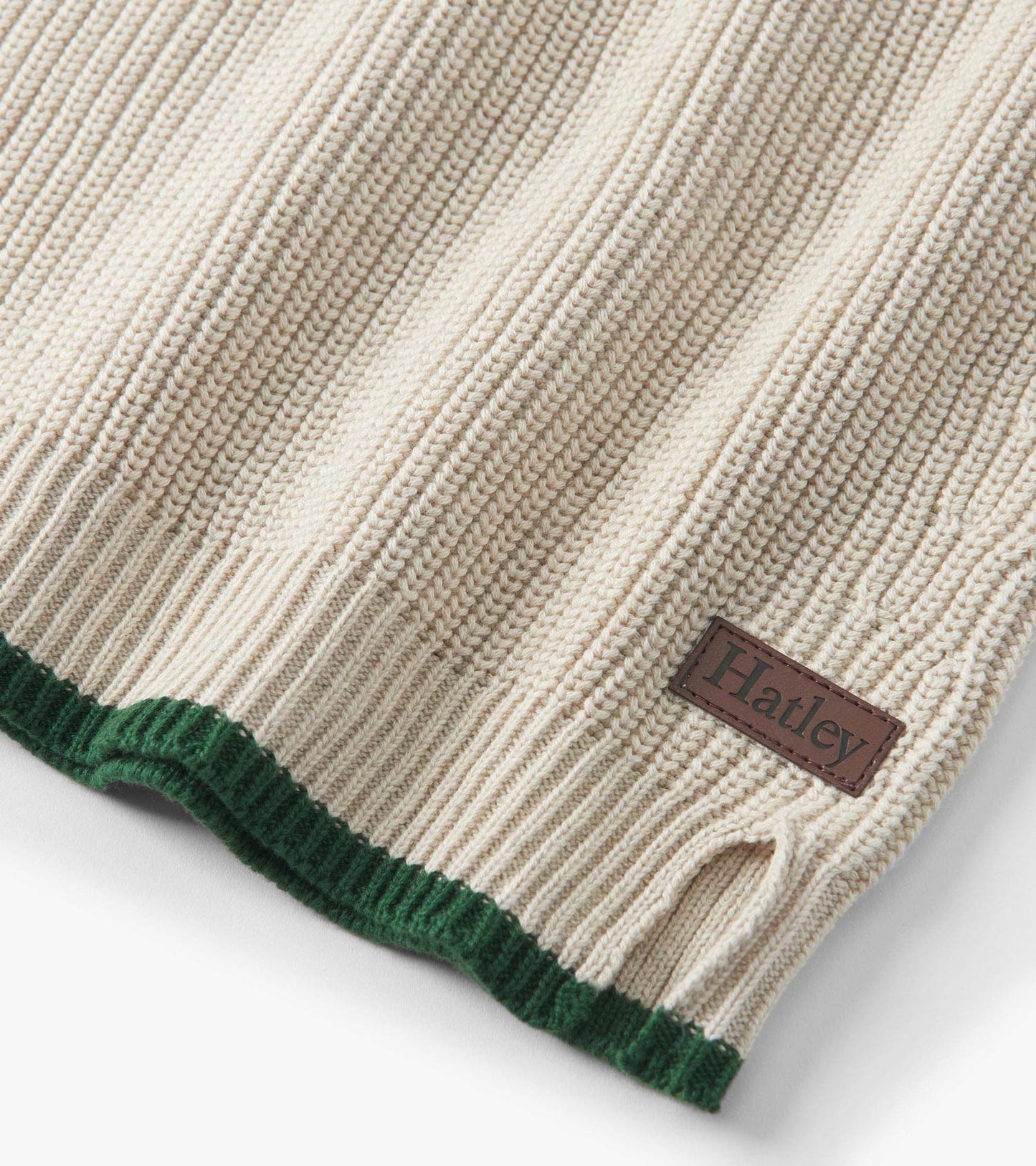 Oatmeal melange sweater with ribbed texture, featuring a green hem and button neck detail.