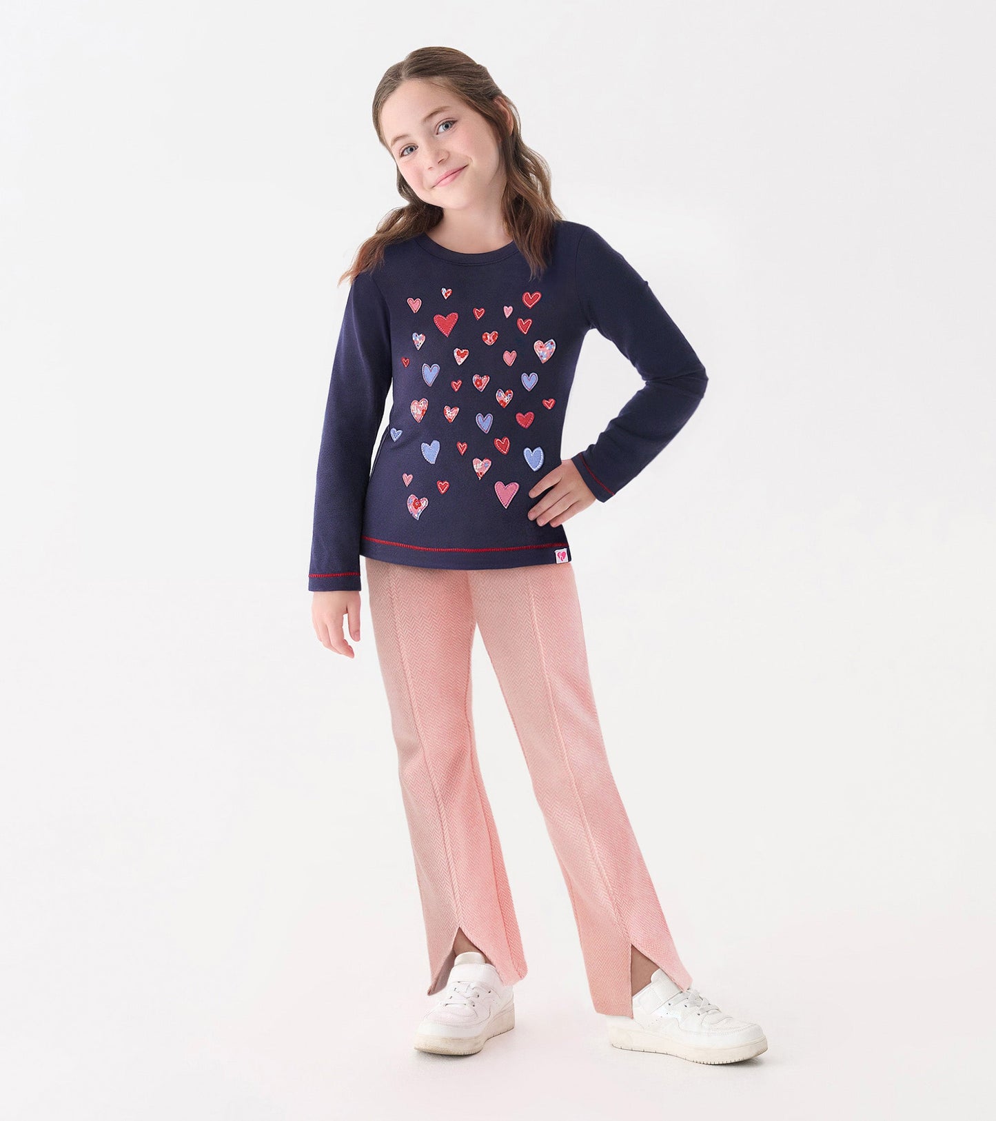 Navy long sleeve tee featuring colorful heart graphics, paired with light pink pants.